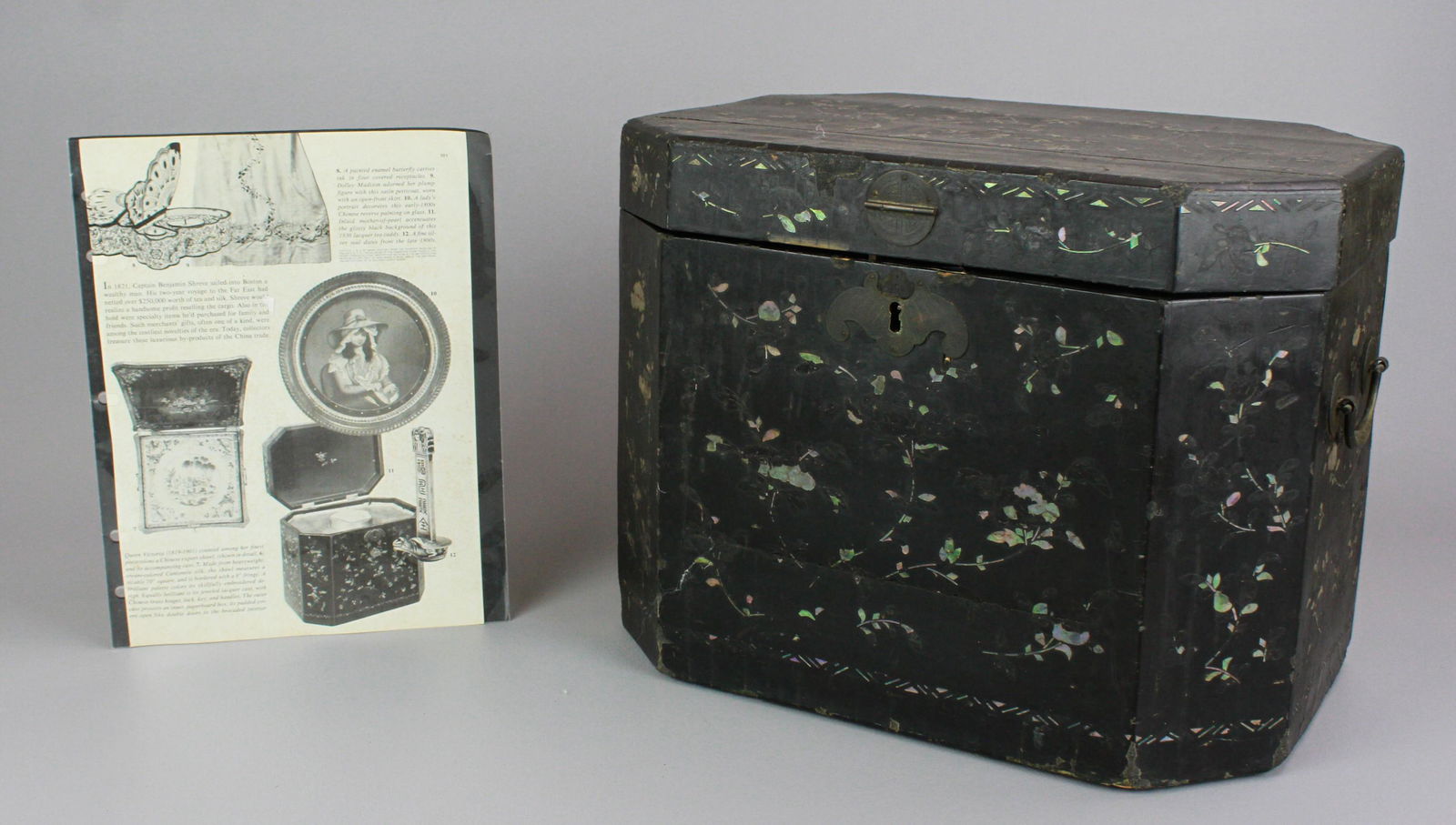 Chinese Inlaid Lacquer Storage Box: Chinese black lacquer mother of pearl inlaid storage box with, bail handles, 14" x 10-1/4" x 11" h, wallpaper interior with losses, wear to surface, losses to inlay