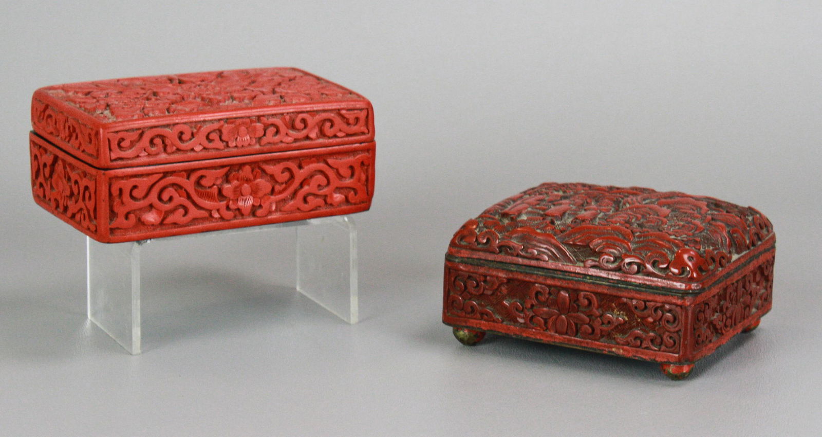 (2) Chinese Cinnabar Boxes: (2) Chinese cinnabar boxes, c/o hinged enamel (3-3/4" x 3" x 1-3/4" h), lacquer (4-1/8" x 2-3/4" x 1-1/2" h)