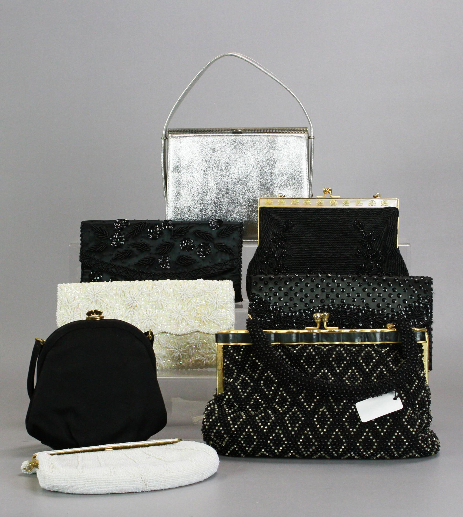 (8) Vintage Evening Bags: (8) Vintage evening bags to include Morris Moskowitz black silk bow bottom bag with ruffled gold tone closure, beaded Walborg 1950's handbag with faux MOP frame in gold rose painted decoration, 50's w