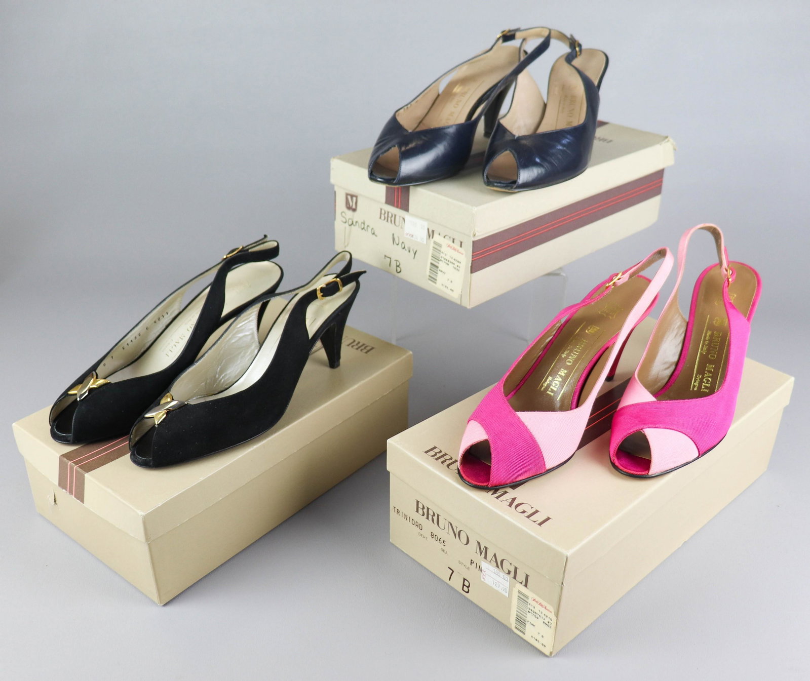 (3) Pair Bruno Magli Pumps: (3) Pair Bruno Magli pumps to include navy leather, 7B with wear at heel and toe, unworn suede slingback black pumps with two-tone cross at toe, 7B, and two-tone pink ribbon slingbacks, unworn, 7B
