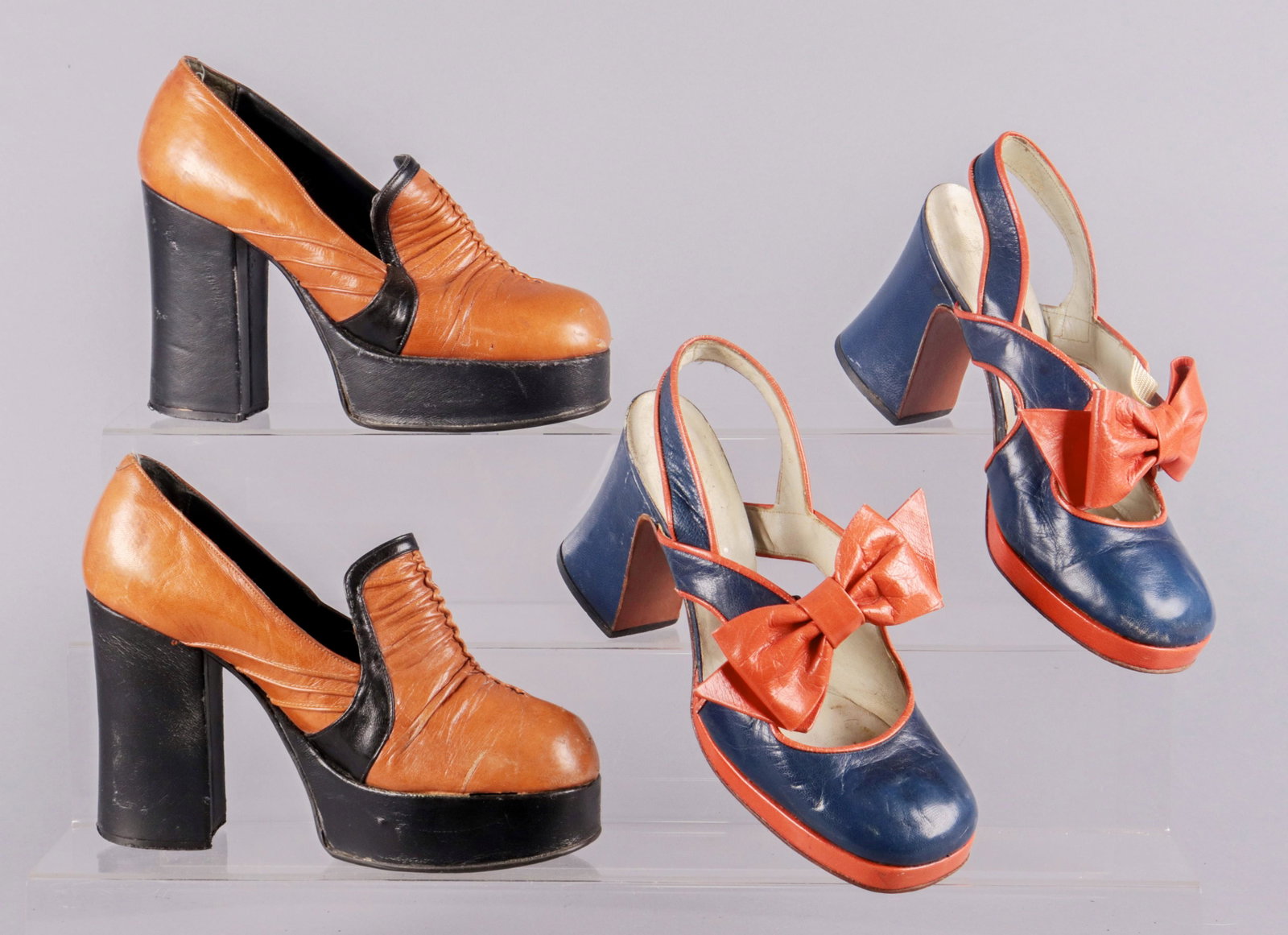 (2) Pair 1960's/70's Platforms: (2) Pair 1960/70's platforms to include black and tan leather platform pump with high chunky heel, coordinating trim and pintuck detail on the vamp and upper, unknown maker, 8" heel to toe and navy bl