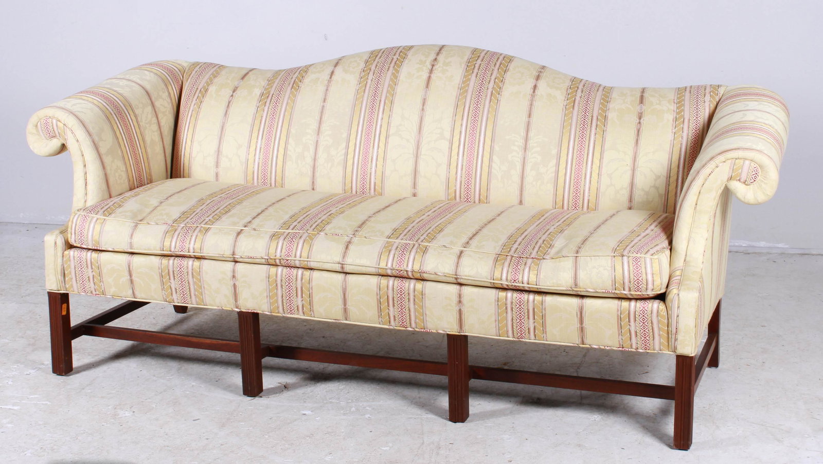 Chippendale style camelback sofa: Chippendale style upholstered camelback sofa, striped upholstery, mahogany stretcher, 41"h x 85"w x 30"d