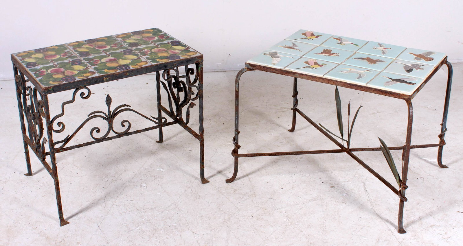 (2) Iron and tile top side tables: (2) Iron and tile top side tables, c/o one with scrolled iron base, fruit tiles, other iron x-base on pad feet with duck tiles, largest 20-1/2"h x 27"w x 20"d