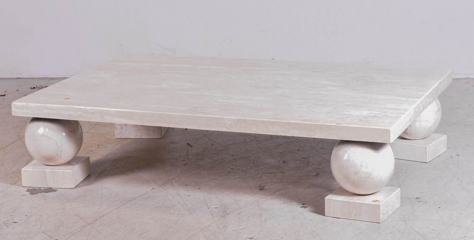 Travertine Deco style coffee table: Travertine Deco style coffee table, rectangular top with ball on square block legs, 13"h x 57-1/2"w x 40"d, small damages to travertine