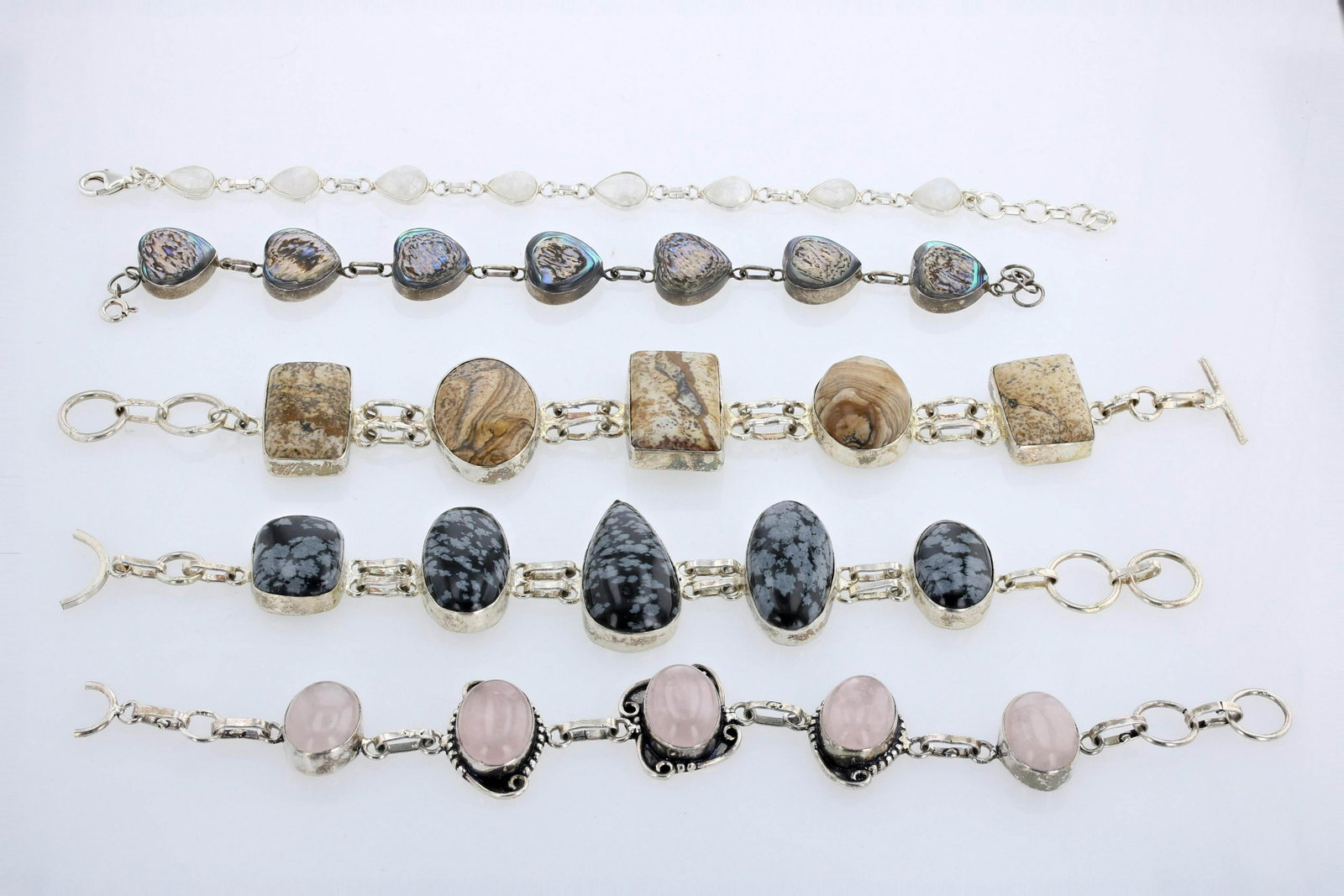 (5) Sterling Silver Gemstone Bracelets: (5) Sterling silver Gemstone Bracelets, bezel set gems, 7.5-8" lengths, moonstones, Mother of pearl, rose quartz and agate gems.Marked 925 but does not test