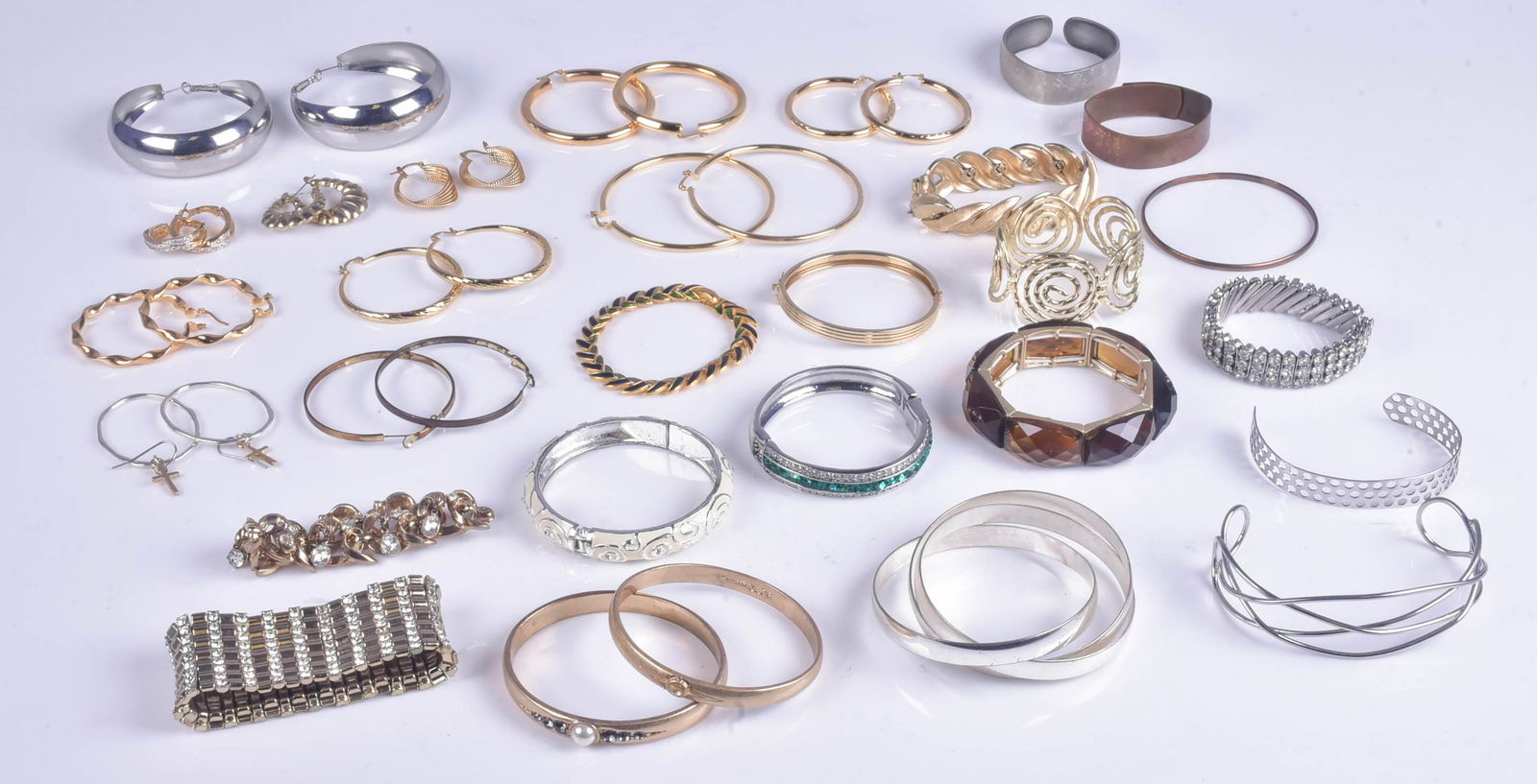 Fashion Costume Bangles and Hoop Earrings: Fashion Costume Bangles and Hoop Earrings Lot C/O: (11) Large gold plated hoop earrings, and (18) fashion bracelets, two signed Trifari