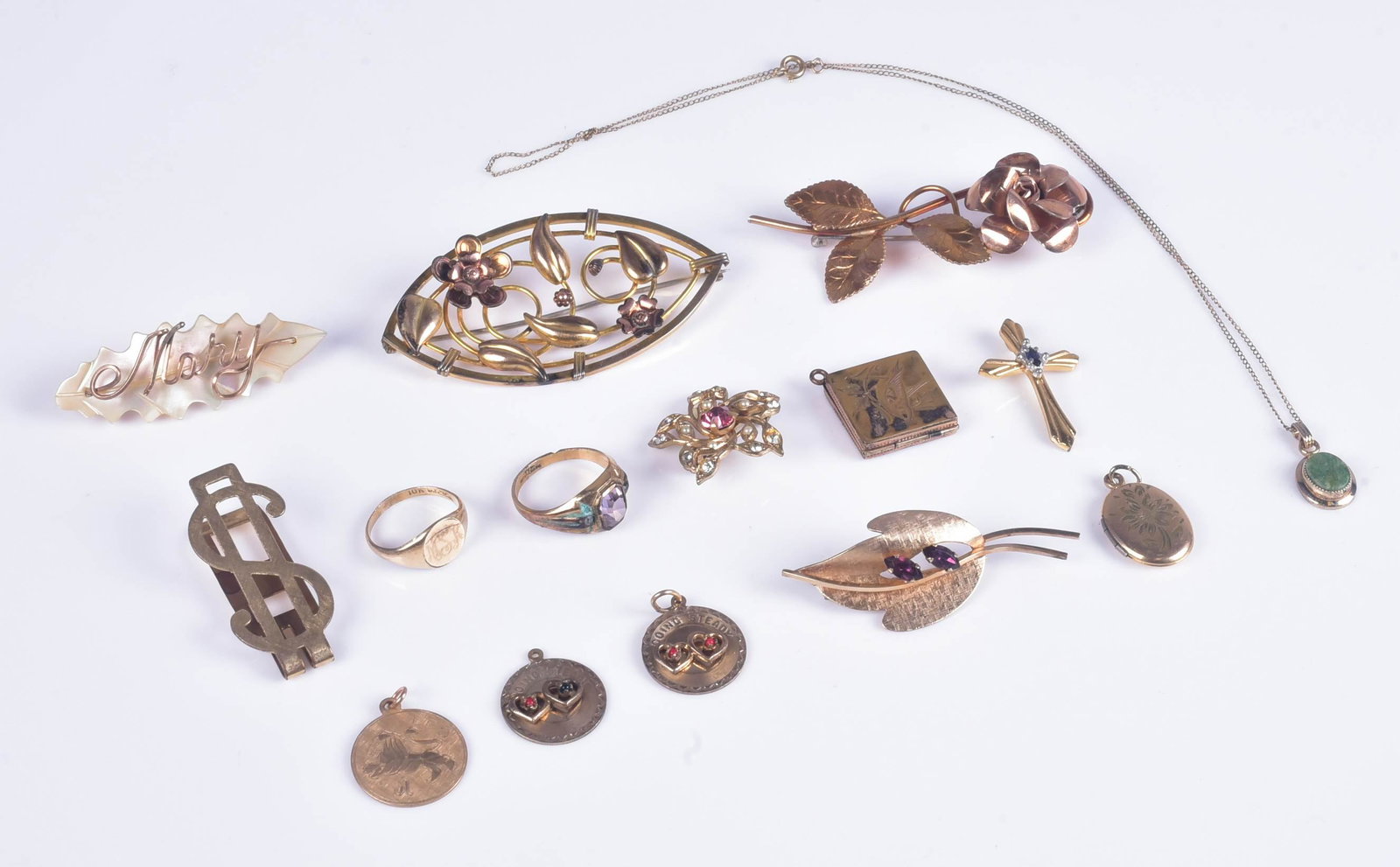 Gold Filled Jewelry Lot: Gold Filled Jewelry Lot, C/O, (1) Krementz Floral brooch, (1) Gold tone brooch with pink crystal, (1) O.B 14/20 $ Money clip, (1) Van Dell 12KT GF. purple stone leaf brooch, (1) MOP gold filled "Mary"