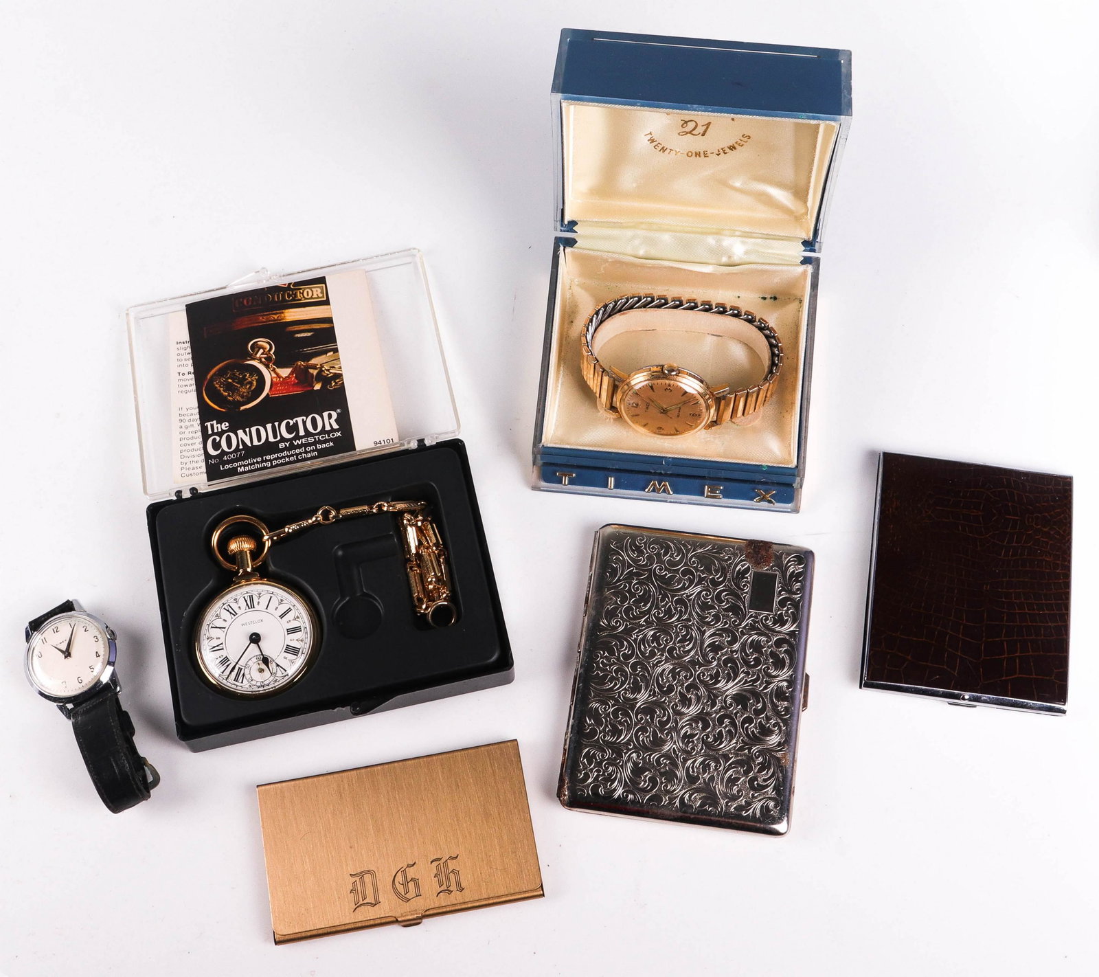 Mens Jewelry: Mens Jewelry lot C/O; (1) Westclox pocket watch in case, (1) Timex in Org. case, self wind, (1) Silvertone white dial mens timex watch, and (3) Metal Cigarette - Business Card cases.
