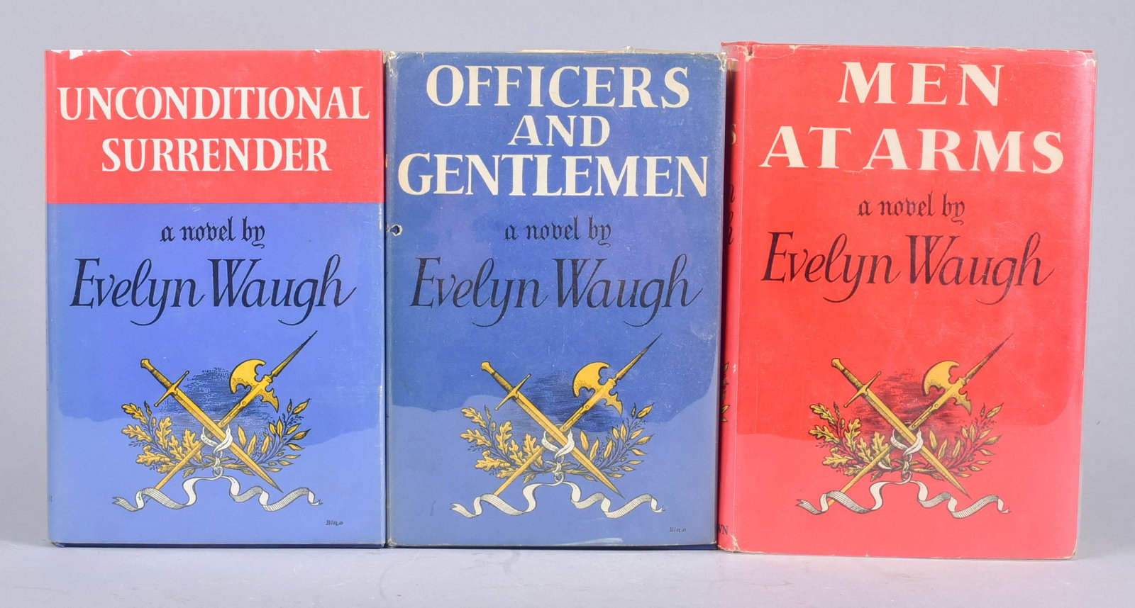 The Sword of Honour Trilogy by Evelyn Waugh: The Sword of Honour Trilogy by Evelyn Waugh, A first edition set including first printings of Men at Arms (1952), Officers and Gentlemen (1955) and Unconditional Surrender (1961); all three in origina