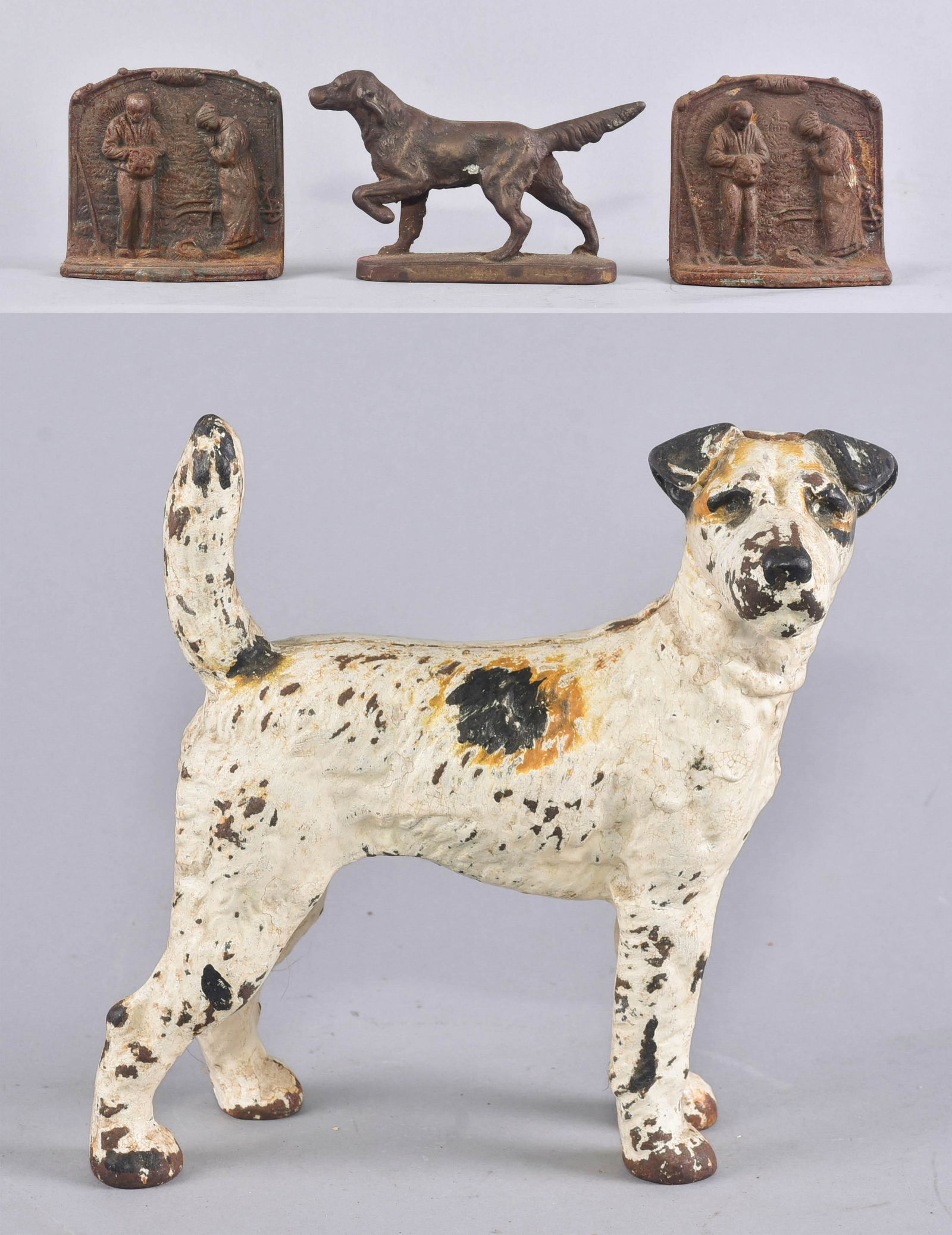 (4) Dog Form Doorstop and Bookends: (4) Dog form doorstop and bookends to include cast iron Irish Setter, 7-1/2" L, 5" H, Hubley style fox terrier door stop, 8-1/2" H x 8" W and pair 'The Angelus' cast iron bookends in much rust, 4-1/2"