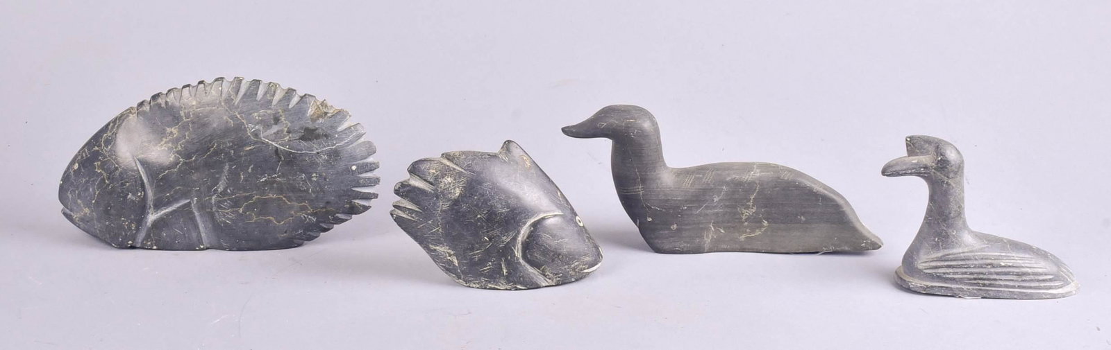(4) Canadian Carved Stone Figures: (4) Canadian carved stone figures, (2) fish forms, 9" L and 5-1/2" L and (2) bird forms, 9"L and 6"L, marked Canada Eskimo Art at underside of each.