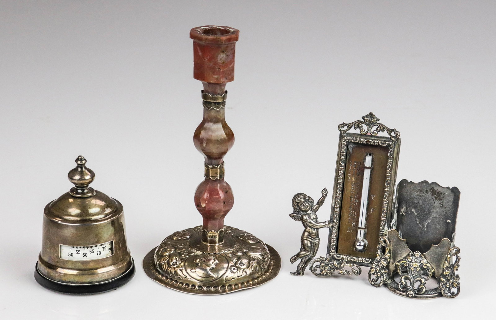 (3) Silver and Sterling Candlestick and Accessories: (3) Silver and sterling candlestick and accessories to include sterling mounted thermometer, embossed plate putti decorated thermometer and stand, and embossed sterling and agate candlestick, damage t