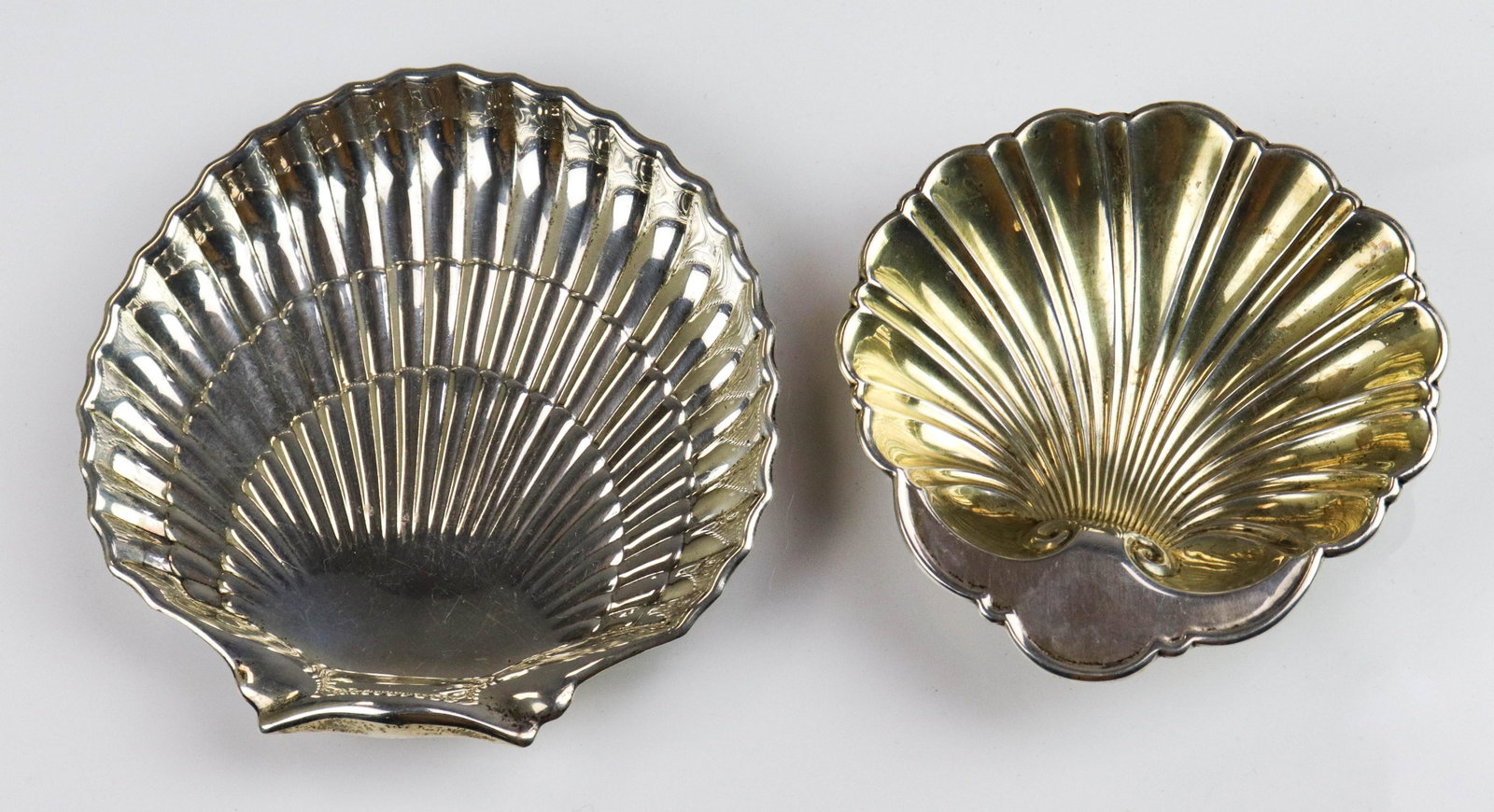 (2) Gorham Sterling Shell Shaped Dishes: (2) Gorham sterling silver shell shaped dishes with ball feet, retailed by JE Caldwell & Co, largest 6" x 6", 8.045