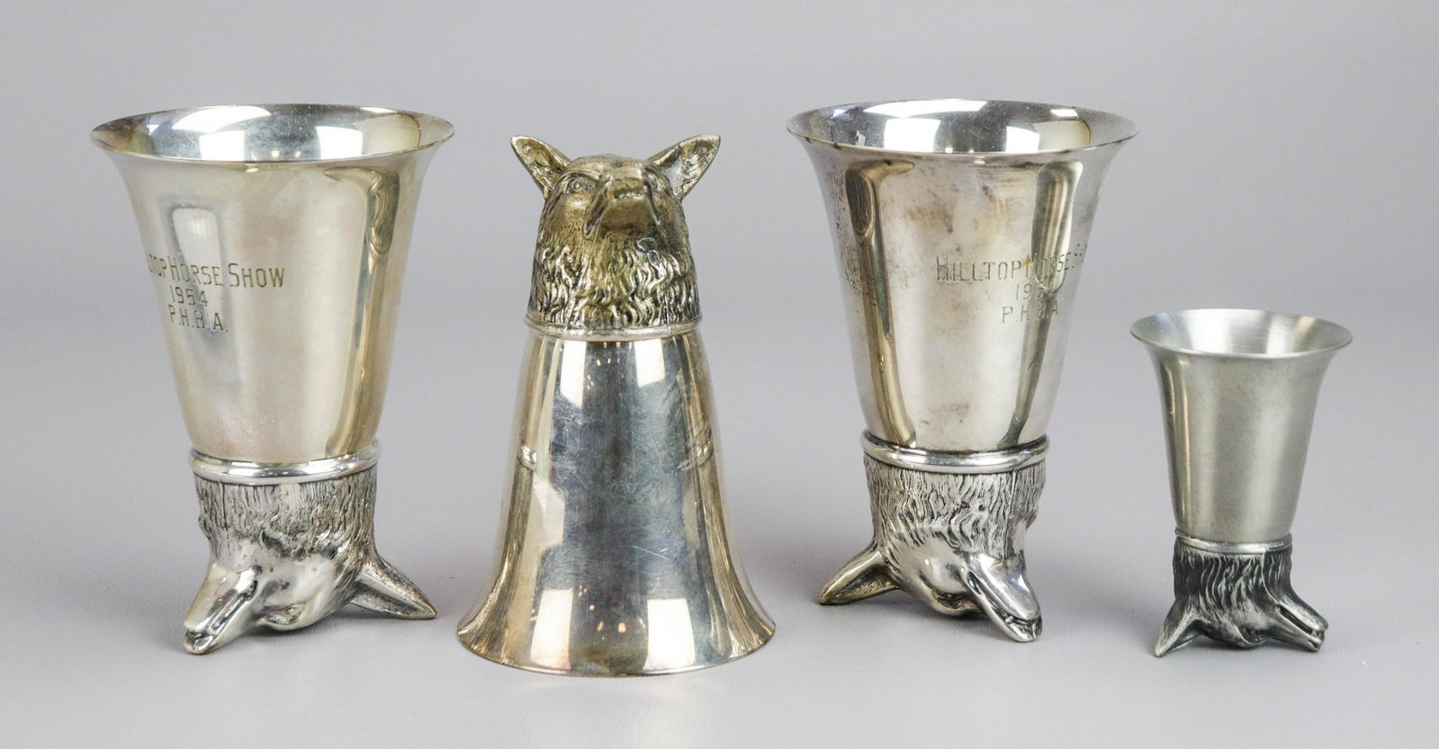 (4) Fox Head Stirrup Cups: (4) Fox head stirrup cups, c/o (3) 5" silver plate (2 with 1954 Hilltop Horse Show engraving), (1) 3-1/4" pewter (with 1962 Radnor Hunt Pony Club engraving