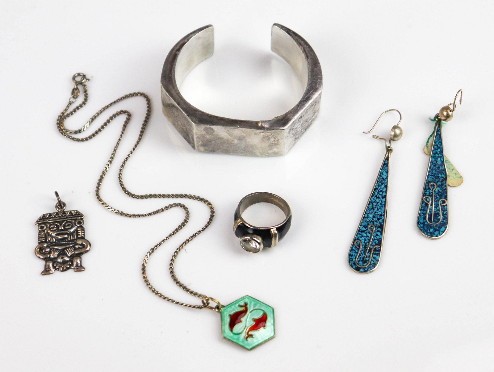 (5) PC Silver Jewelry Group: (1) 20mm wide Made in Mexico Cuff " Talleres de los Ballesteros"; in worn condition, dents, oxidation; (1) silvertone ring with black enamel finish, SZ. 7.5, (1) 900 silver native depiction charm 30x2