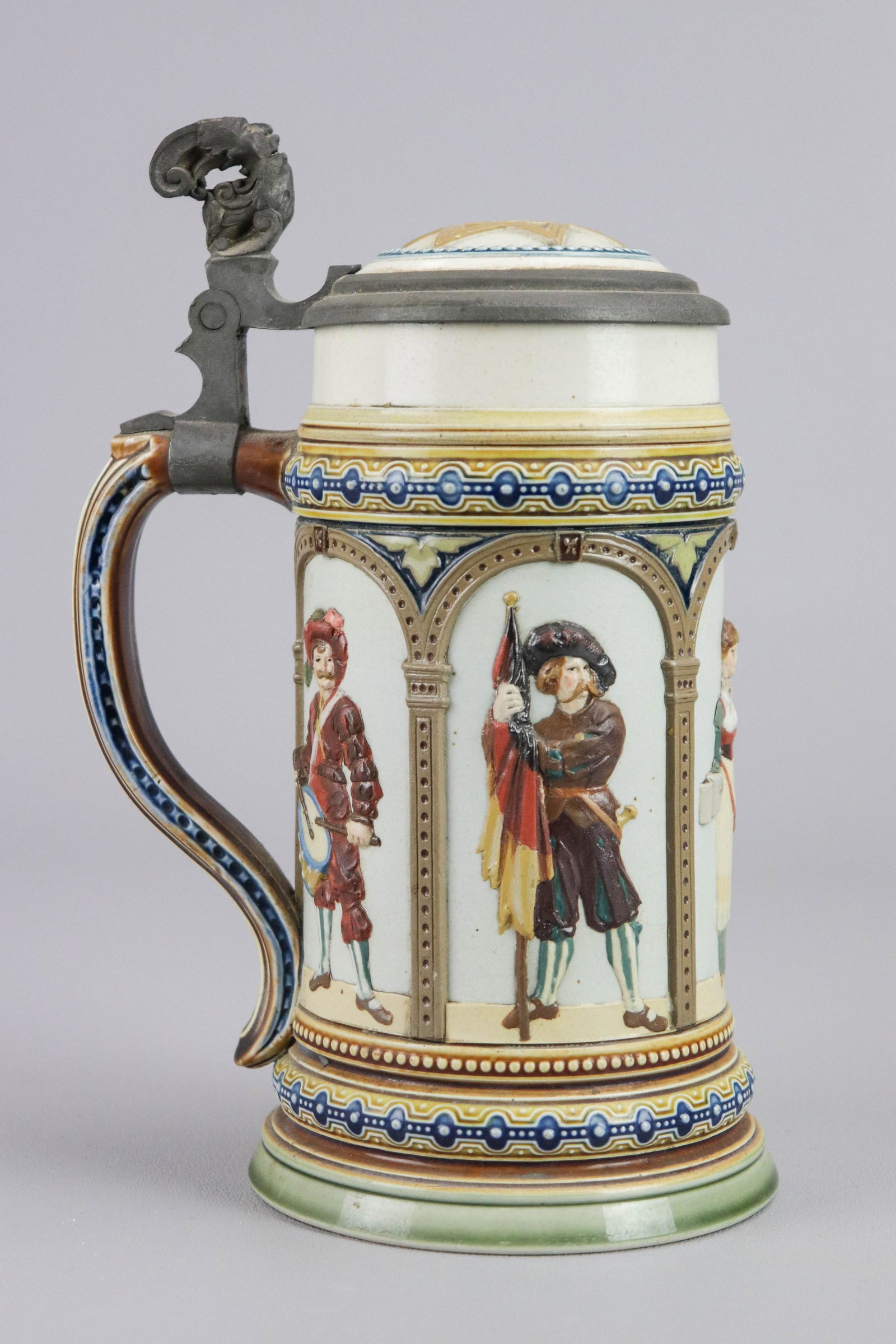 Mettlach 1/2 Liter Stein #1809: Mettlach 1/2 liter stein, relief barmaid & cavaliers, impressed on base "1809 II 89", printed in blue "10", lacking castle mark, porcelain inset lid with Star of David, pewter figural thumb lever, 8-1