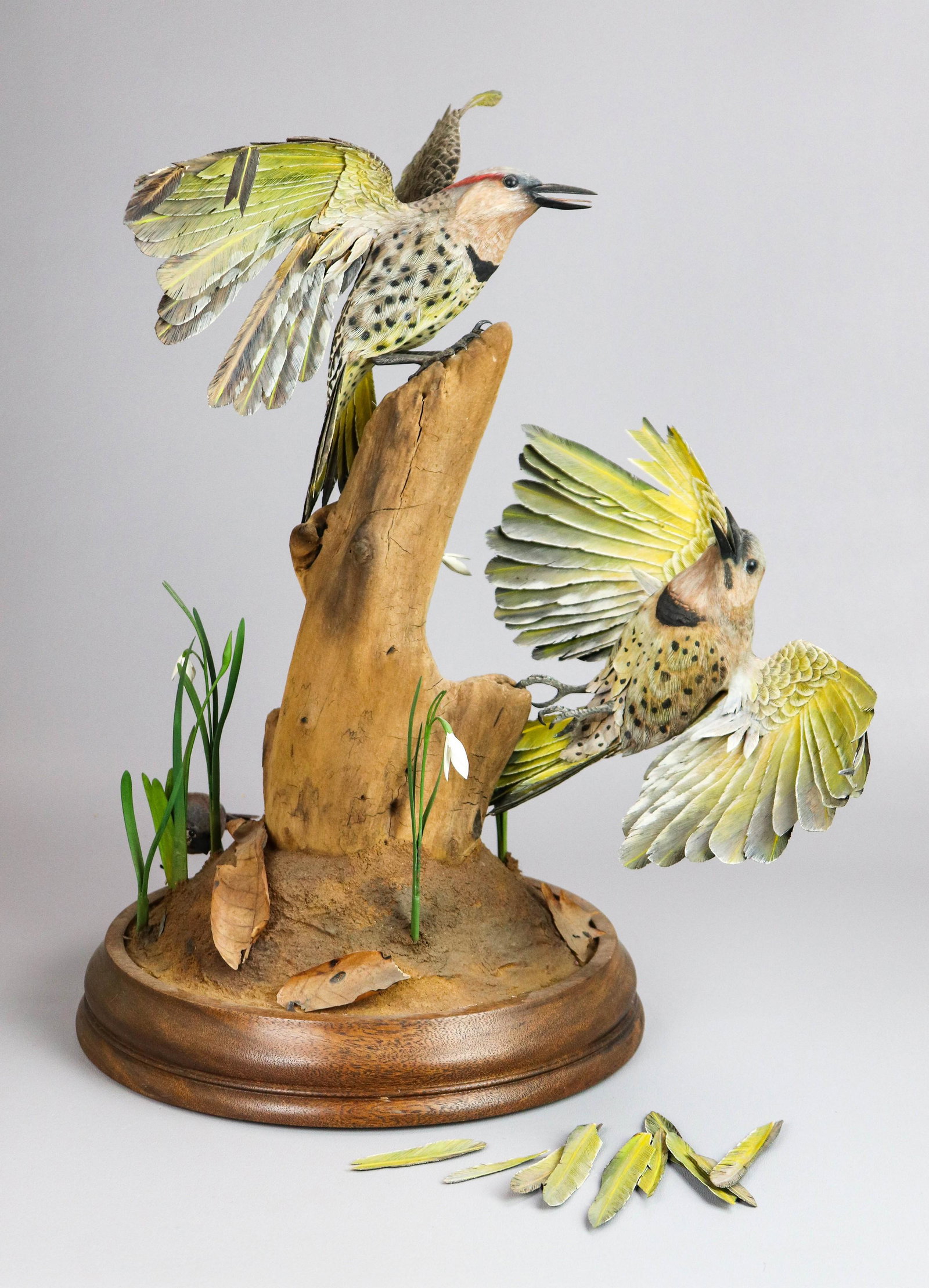 John Neal Mullican Custom Bird Sculpture: John Neal Mullican custom bird sculpture, in wood, depicting pair yellow shafted flickers on formed wood, leaf and floral base, (1) bird detached with losses, (1) attached with losses, 20-1/2" H, in f