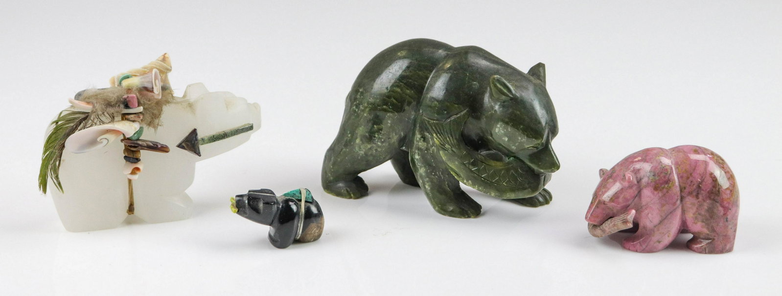 (4) Carved Stone Bear Fetishes: (4) Native American carved stone bear fetishes, with shell, turquoise, and other stone embellishment, largest 3" h x 5" l