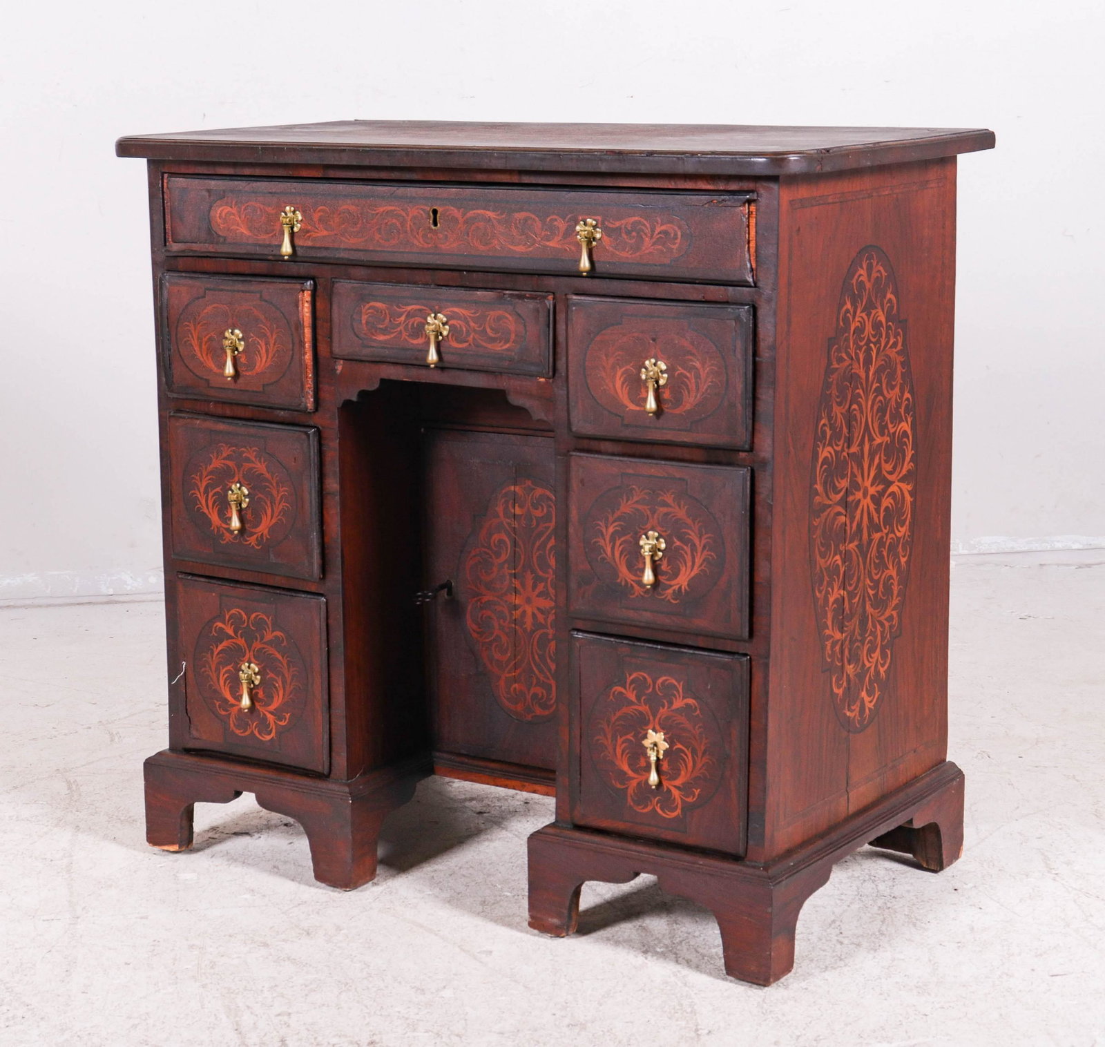 English Mahogany inlaid desk: English Mahogany inlaid desk, scrolled inlaid decoration, center drawer over 3 drawers on each side, center drawer with lock and key, 30"h x 30-1/2"w x 16"d, veneer damage to left back corner, mouldin