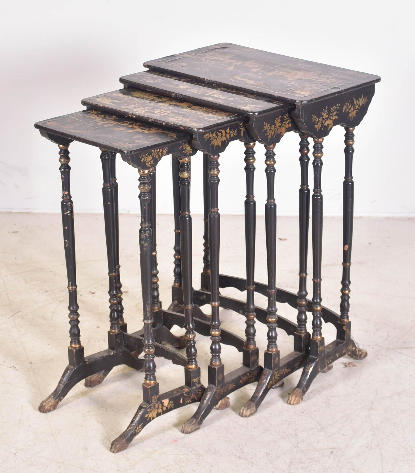 Chinoiserie paint decorated nesting tables: Chinoiserie paint decorated nesting tables, ebonized with gilt highlights, landscape scenes on tops, largest 29"h x 19-1/2"w x 12"d, wear to paint, some tops with lacquer lifting