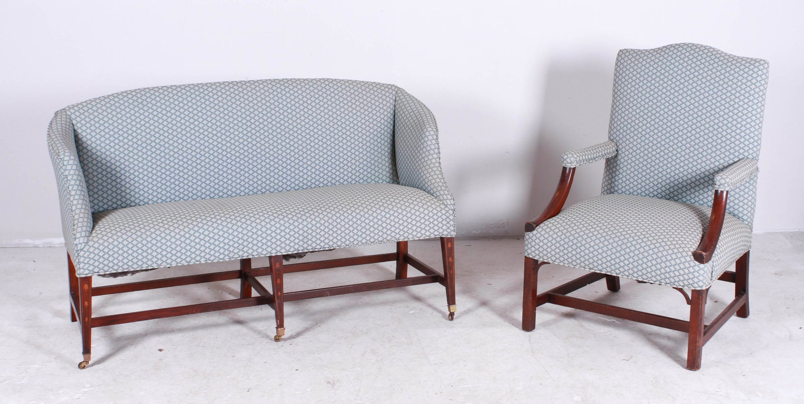 Bellflower Inlaid Hepplewhite Settee, Lolling Chair: Bellflower Inlaid Mahogany Hepplewhite Settee, bellflower inlay on legs, dovetailed stretcher base, tapered legs with brass cup castors, 19th c, 35"h x 59"w x 21"d; along with a mahogany Martha Washin