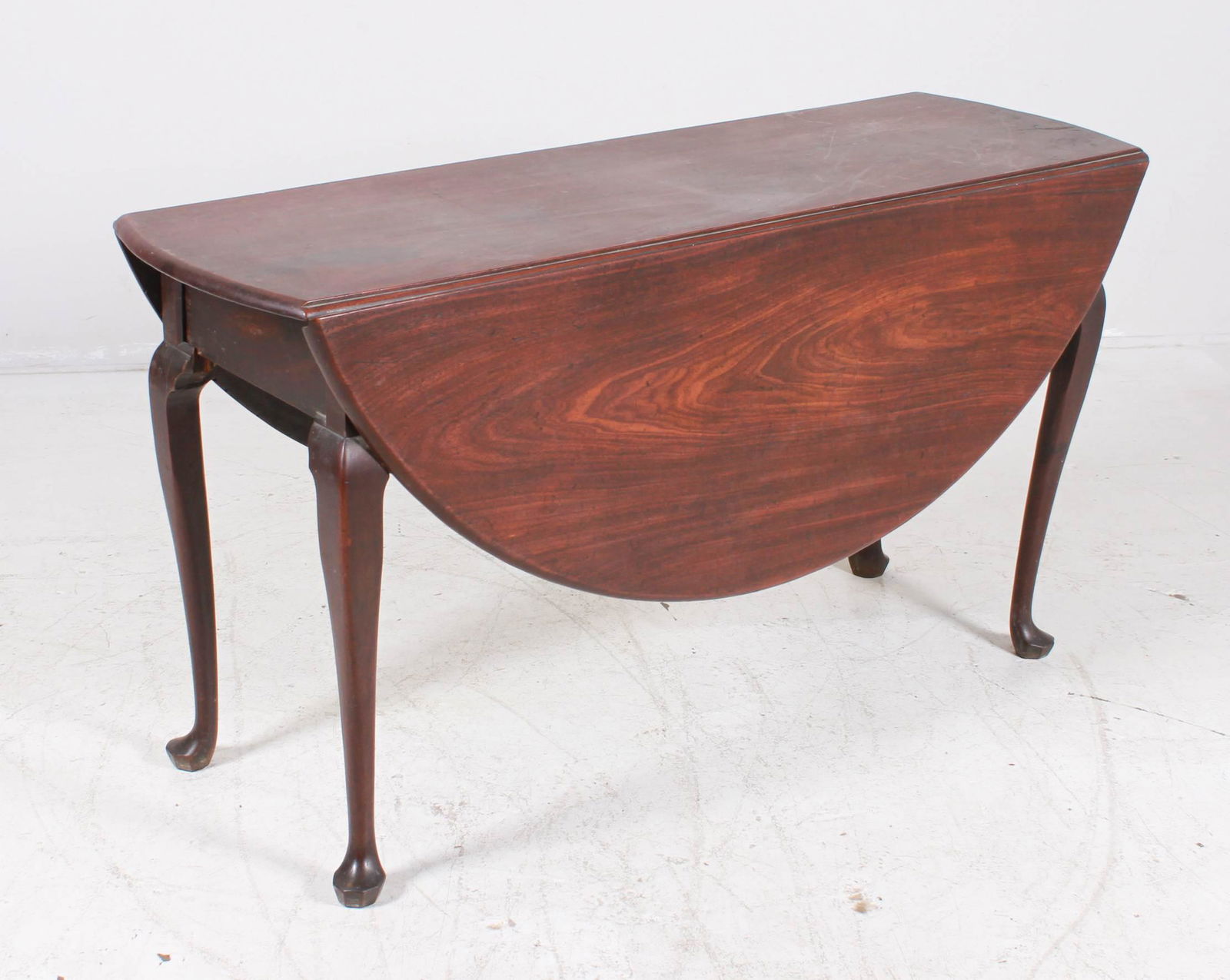 Mahogany QA drop leaf table: Mahogany QA drop leaf table, 4 leg base, rounded leaves, cabriole legs with pad feet, some losses and repairs, 28"h x 51"w x 16"d, two 18"w leaves, Mahogany QA drop leaf table, 4 leg base, rounded lea