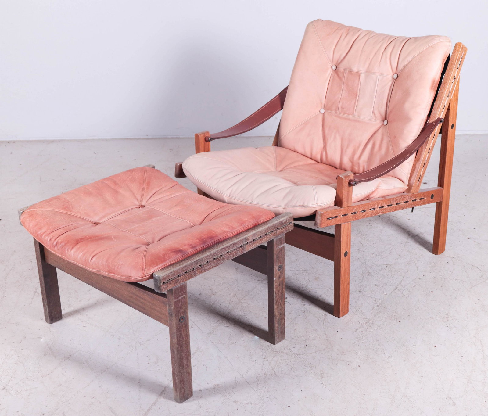 Modern Design lounge chair w/ footstool: Modern Design lounge chair w/ footstool, teak laminate frame, brown leather cushions, brown leather arms, 32"h x 29"w x 29"d, sun fading to leather