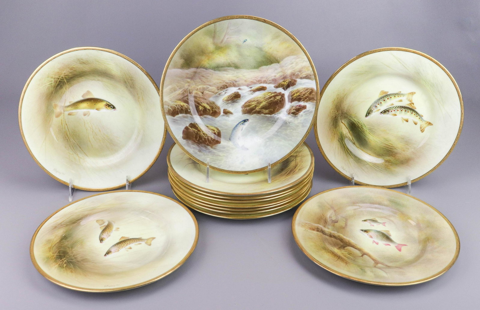 (12) Tiffany Royal Doulton Fish Plates: (12) Royal Doulton hand painted fish plates, all different, gold encrusted border, retailed by Tiffany & Co , 9-3/8" dia, c/o (7) signed J Birbeck, (5) signed R Perry, no condition issues noted