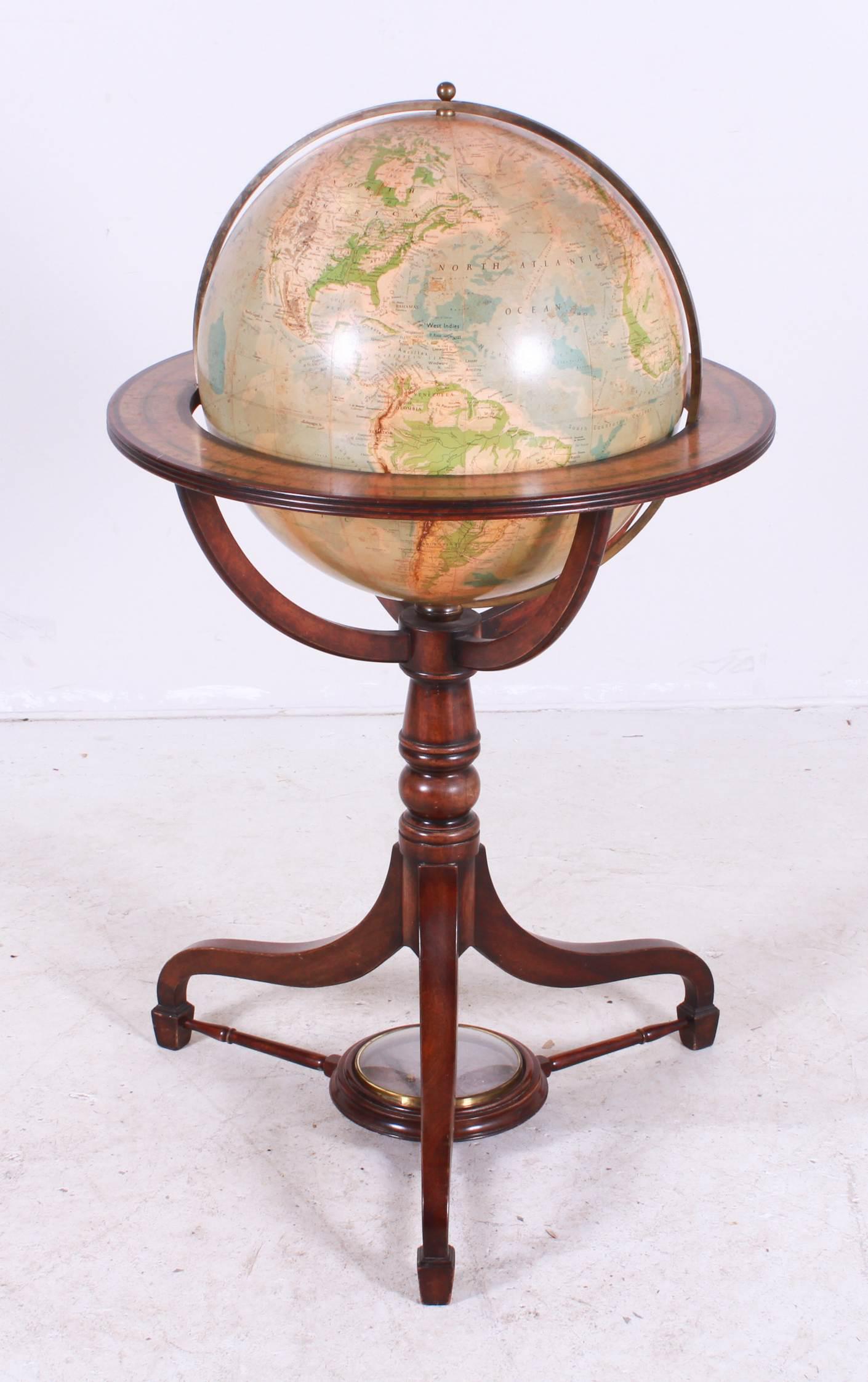 Georama 19" Terrestrial Globe on Mahogany Stand: Georama 19" Terrestrial Globe on Mahogany Stand, arched spider leg inlaid base containing a faux compass, cartography by George Philip & Son Limited, London, horizontal band surrounding the equator de