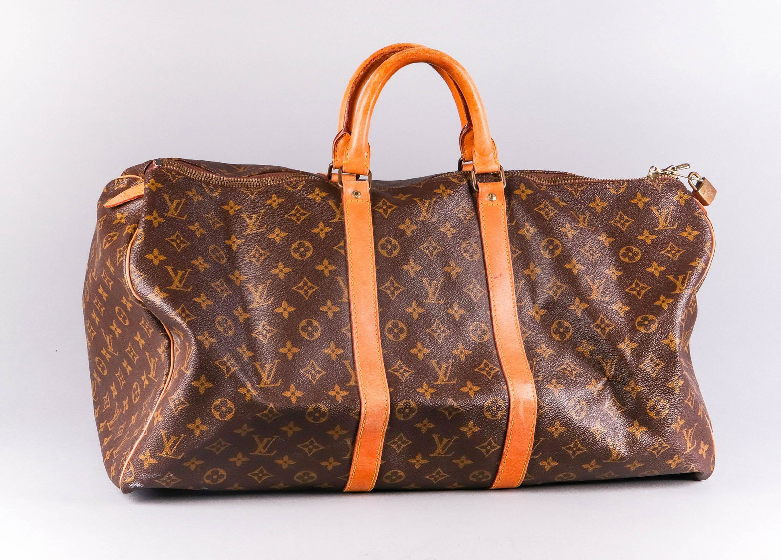 Louis Vuitton Duffle Bag: Louis Vuitton monogrammed duffle bag, marked "Made in France", stamped inside "SP" & "844", lock but no key, 22" w x 10" d x 11" h