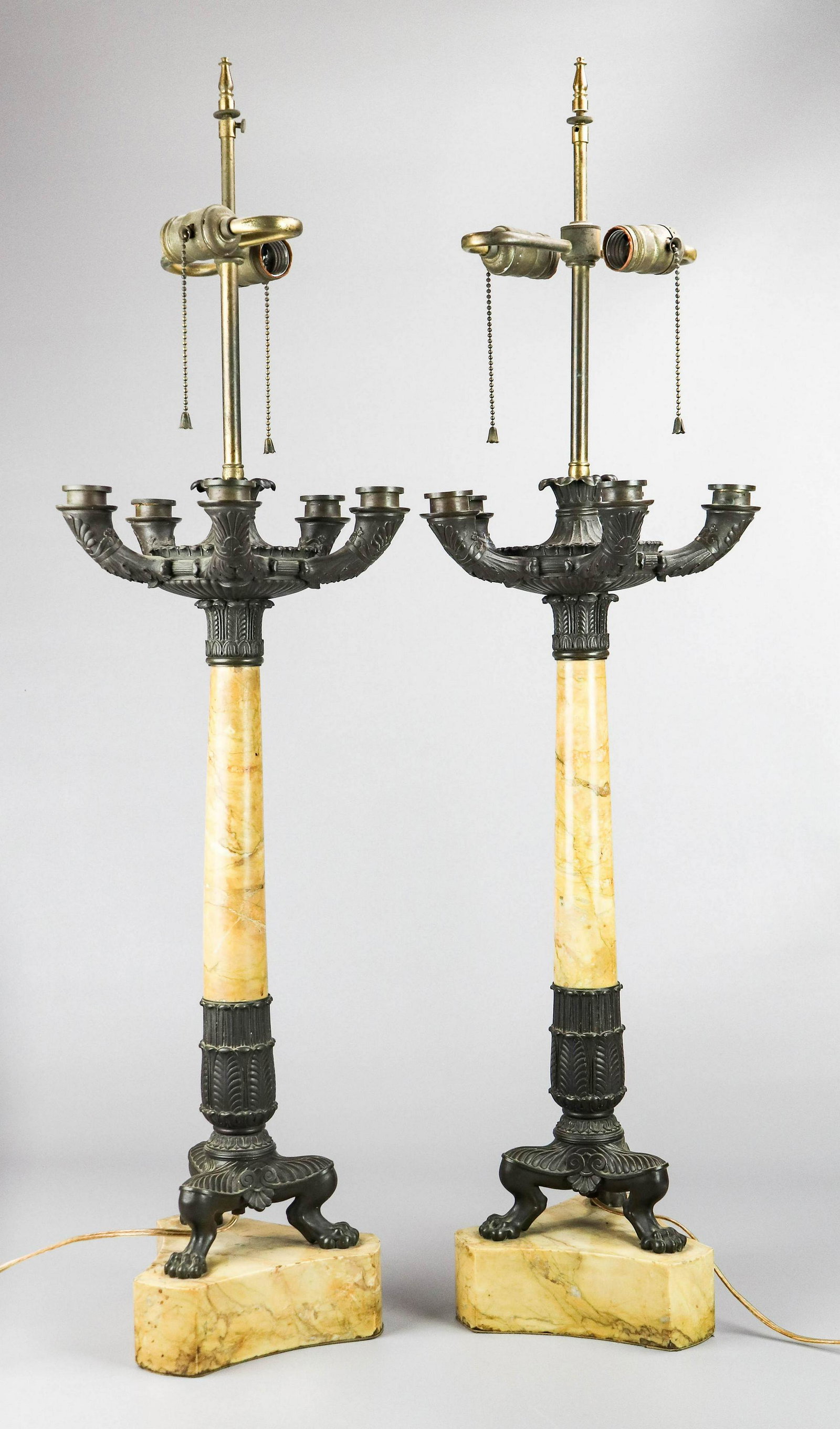 Pair Italian style bronze and marble candelabra table: Pair Italian style bronze and marble candelabra table lamps, 5 candleholders, acanthus leaf decoration with paw feet, 36"h to top of finial, Yes, working condition, hairlines throughout marble, flea b