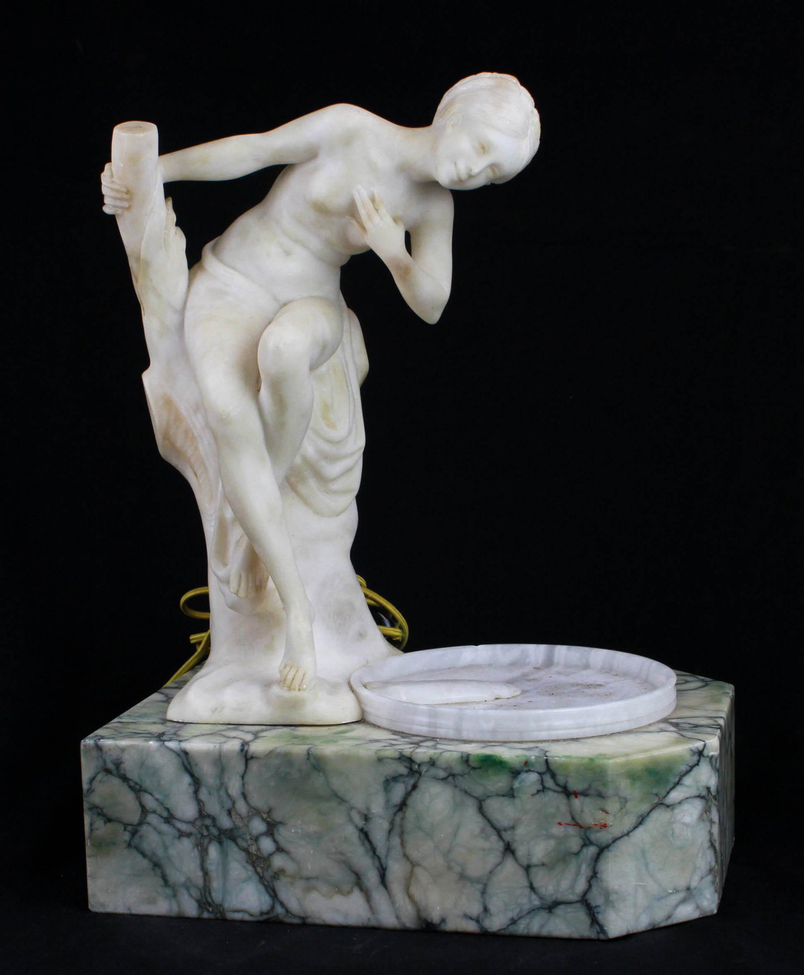 Marble and alabaster table lamp: Marble and alabaster table lamp, nude figure gazing into a pul on a black veined marble base, unsigned, base is hollowed out with light under the pull, 19"h x 13-3/4"w x 9-3/4"d