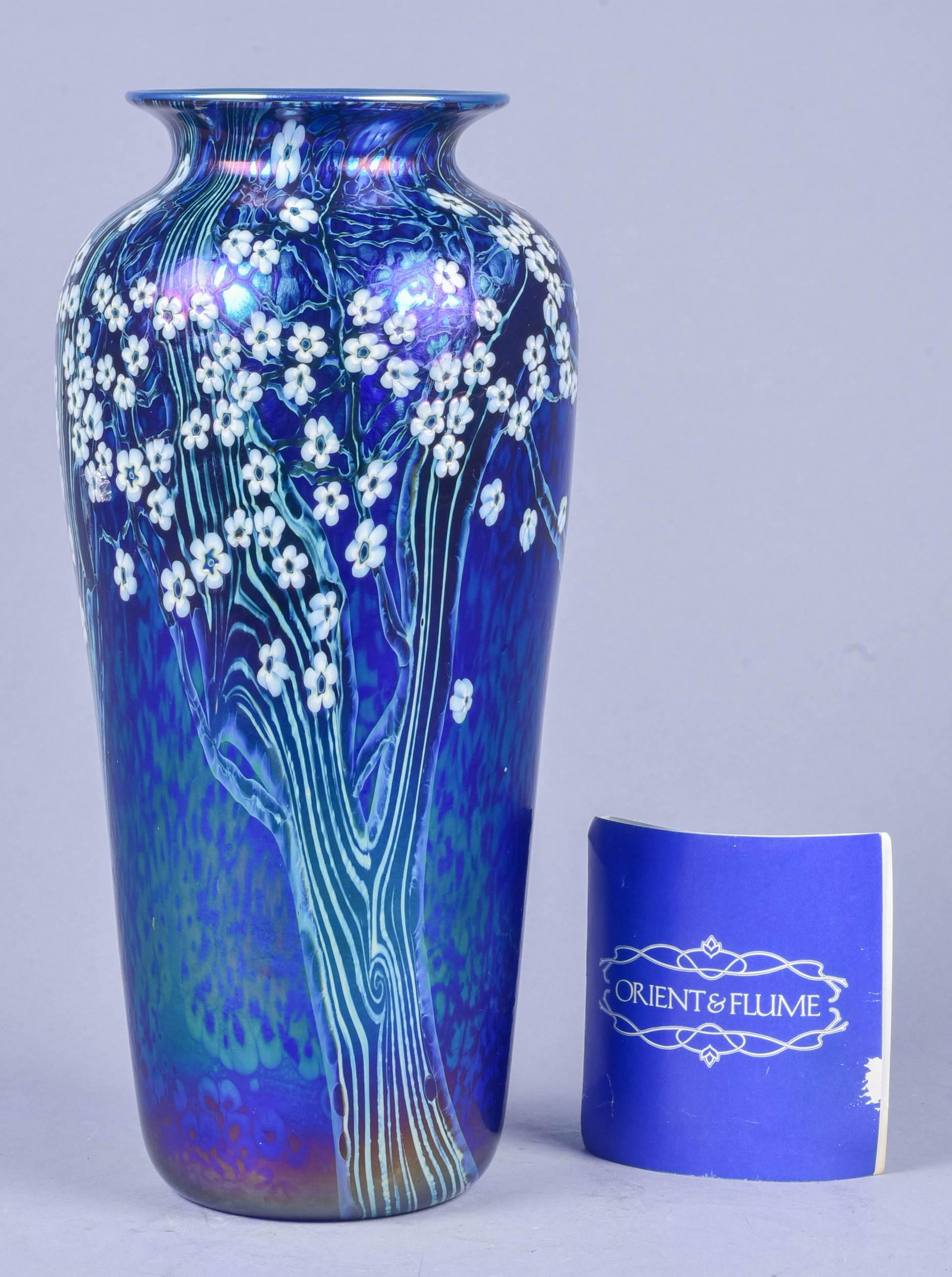 Orient and Flume Art Glass Vase: Orient and Flume art glass vase, signed at underside, depicting tree in bloom, with original tag marked 1981 July 19, 11" h, Scratches to underside, no other issues