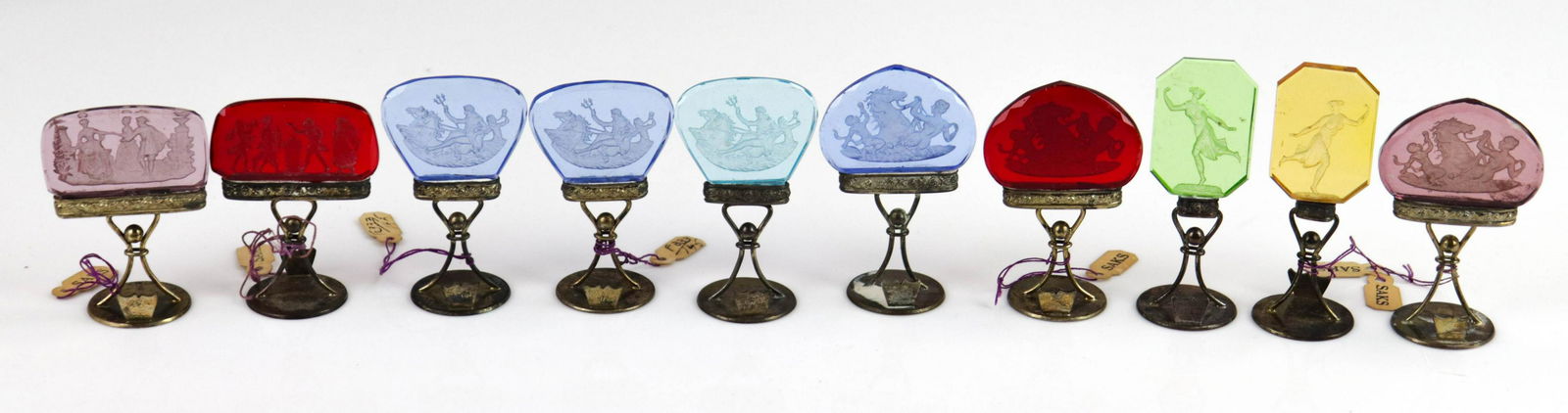 (10) Cameo Glass Place Card Holders: (10) Reverse carved cameo glass place card holders, classical figures, various colors, made in Austria, retailed by Saks, tallest 2-3/4"