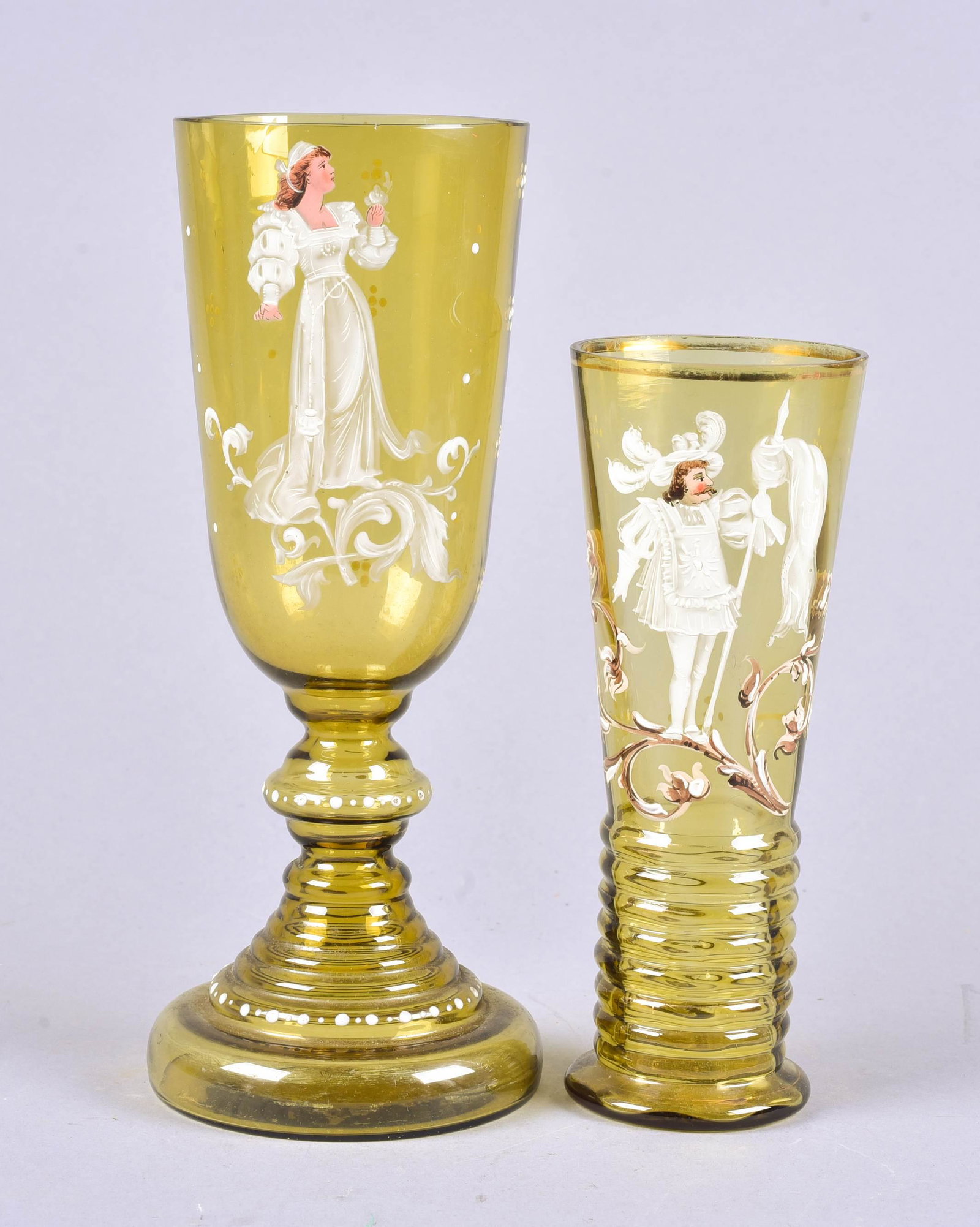 (2) Riedel Style Ale Glass and Chalice: Riedel style ale glass and chalice to include olive enamel painted ale glass, ribbed foot, depicting kingly figure among scroll decoration, 7-3/4"h and olive enamel painted chalice, queenly figure at 