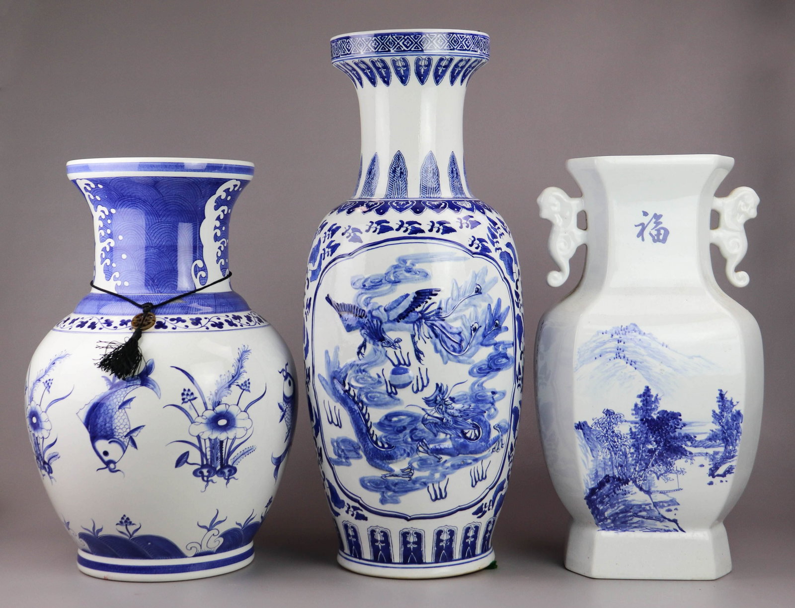(3) Chinese Blue & White Porcelain Vases: (3) Chinese blue & white porcelain vases, foo dog handles, landscape & calligraphy, marks to base (19-1/4" h), Rouleau vase, dragon & floral decoration, unmarked (25-1/4" h), koi fish & flower decorat