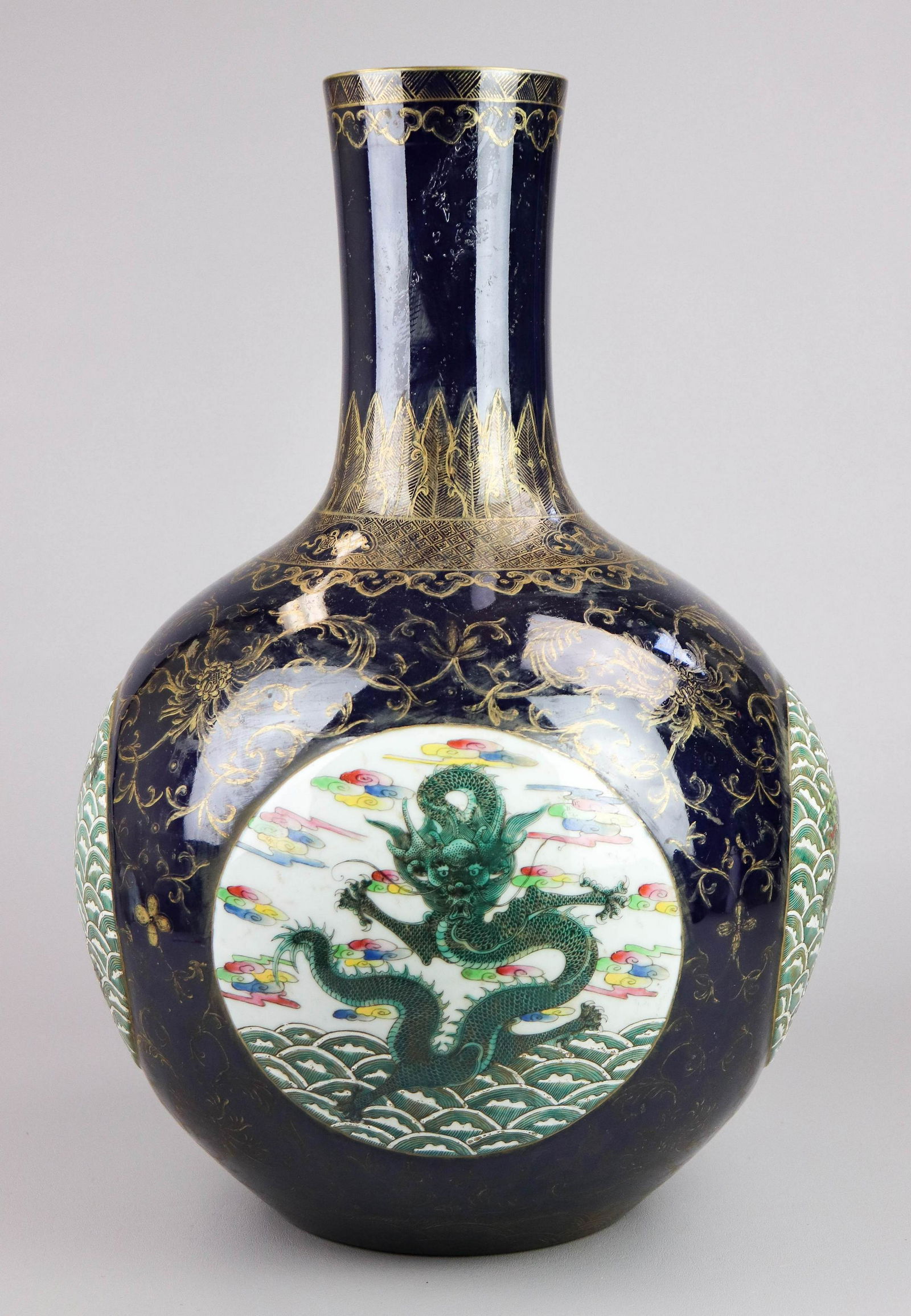 Large Chinese Porcelain Bottle Vase: Chinese porcelain bottle vase, cobalt ground with gold decoration, dragon medallions, seal mark to base, 20" h x 12" dia