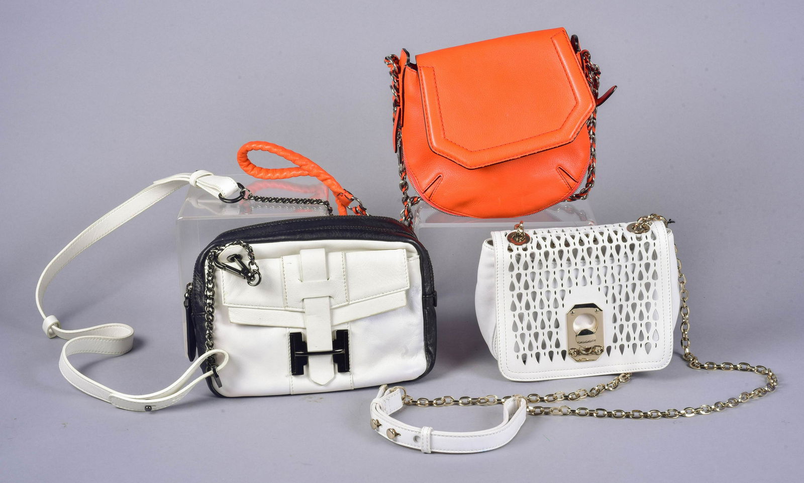 (3) Crossbody Bags: (3) Crossbody bags to include Halston Heritage two tone leather bag, gunmetal hardware and adjustable strap, 9-1/2"L, 6"H, scuffs and wear, Stuart Weitzman pierced faux leather bag, chain strap and me