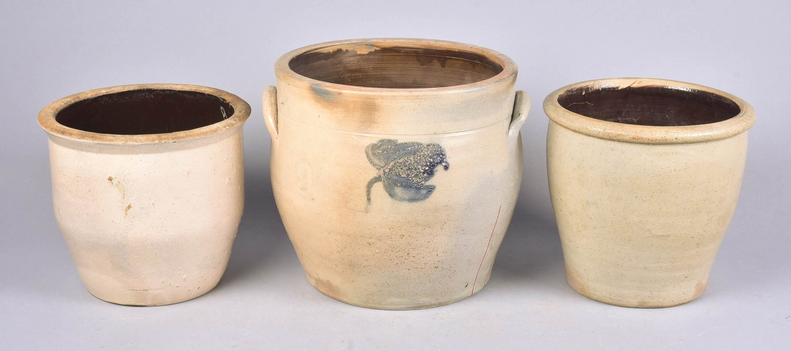 (3) Ovoid Stoneware Crocks: (3) Ovoid stoneware crocks, c/o 2-gallon with ear handles, cobalt blue flower decoration (9-1/4" h x 10" dia, hairline to side, interior chip), unmarked 1-gallon (8" h x 8-1/2" dia), unmarked 1-gallon