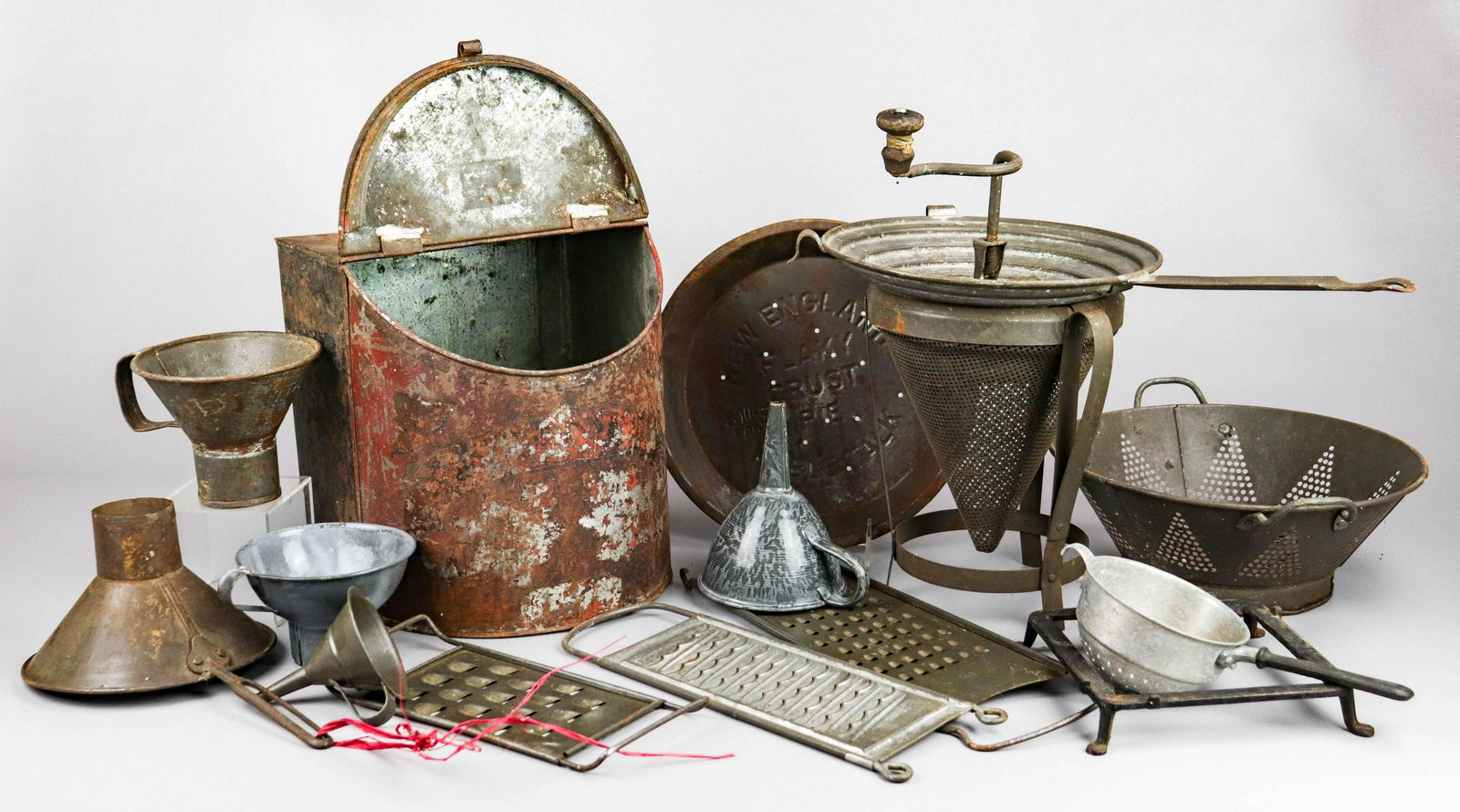(15) Pcs Metal Kitchenware: (15) Pcs metal kitchenware, including funnels, strainers, graters, grinders, colander, New England Table Talk Flaky Crust Pie plate, bin