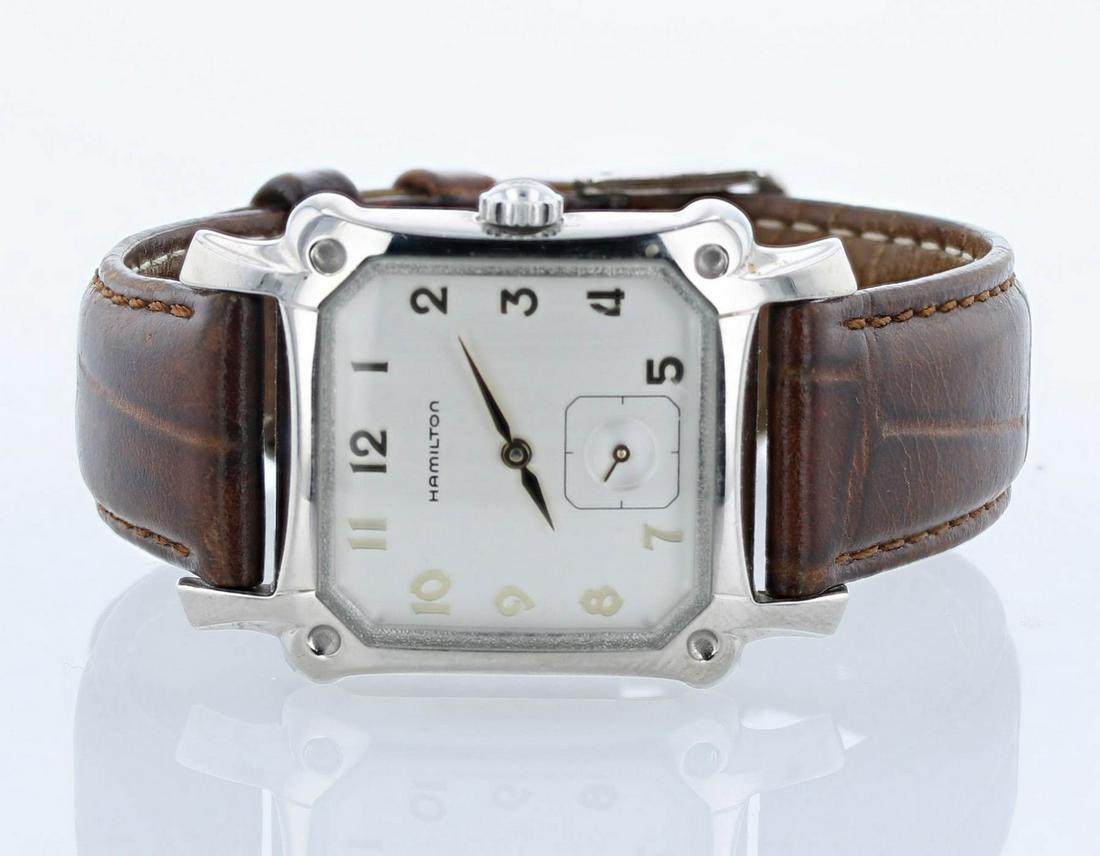 Men: A Men's Hamilton 6295 Square watch, ss case, brown leather band, gold tone markers 28.8x39.5mm case including lugs, 18mm band.This watch has a quartz movement.