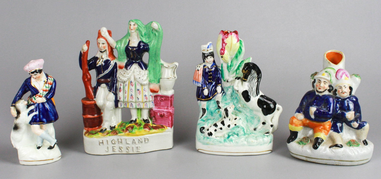 (4) Staffordshire figures: (4) Staffordshire figures to include 19th c. Staffordshire figure of young Scottish woman with dog, restored, 6-3/4"h, figural group "Highland Jessie", 9"h, and (2) multi-figure spill vases.