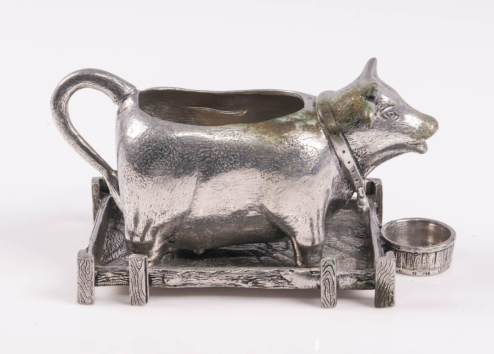 Pewter Pierre Deux Creamer and Underplate: Pewter Pierre Deux creamer and underplate to include figural cow form creamer on wood grain patterned underplate, 5-1/4"L