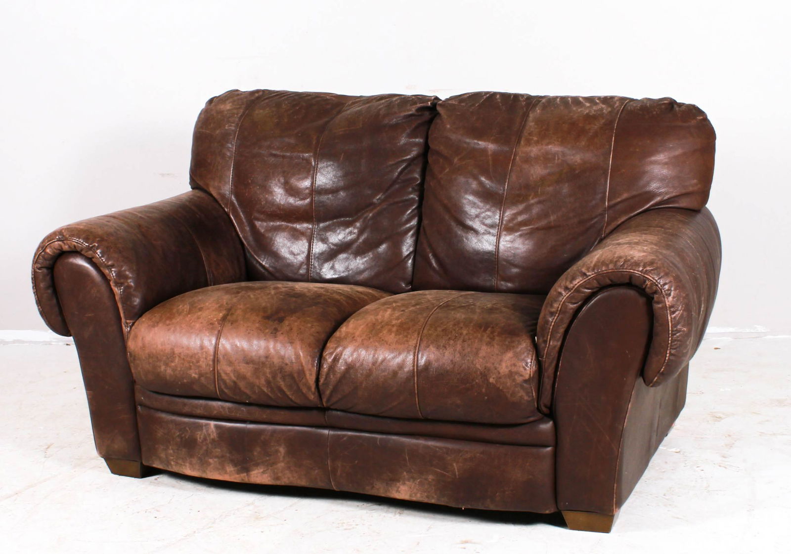Distressed leather loveseat: Distressed leather loveseat, brown leather, 38"h x 68"w x 36"d