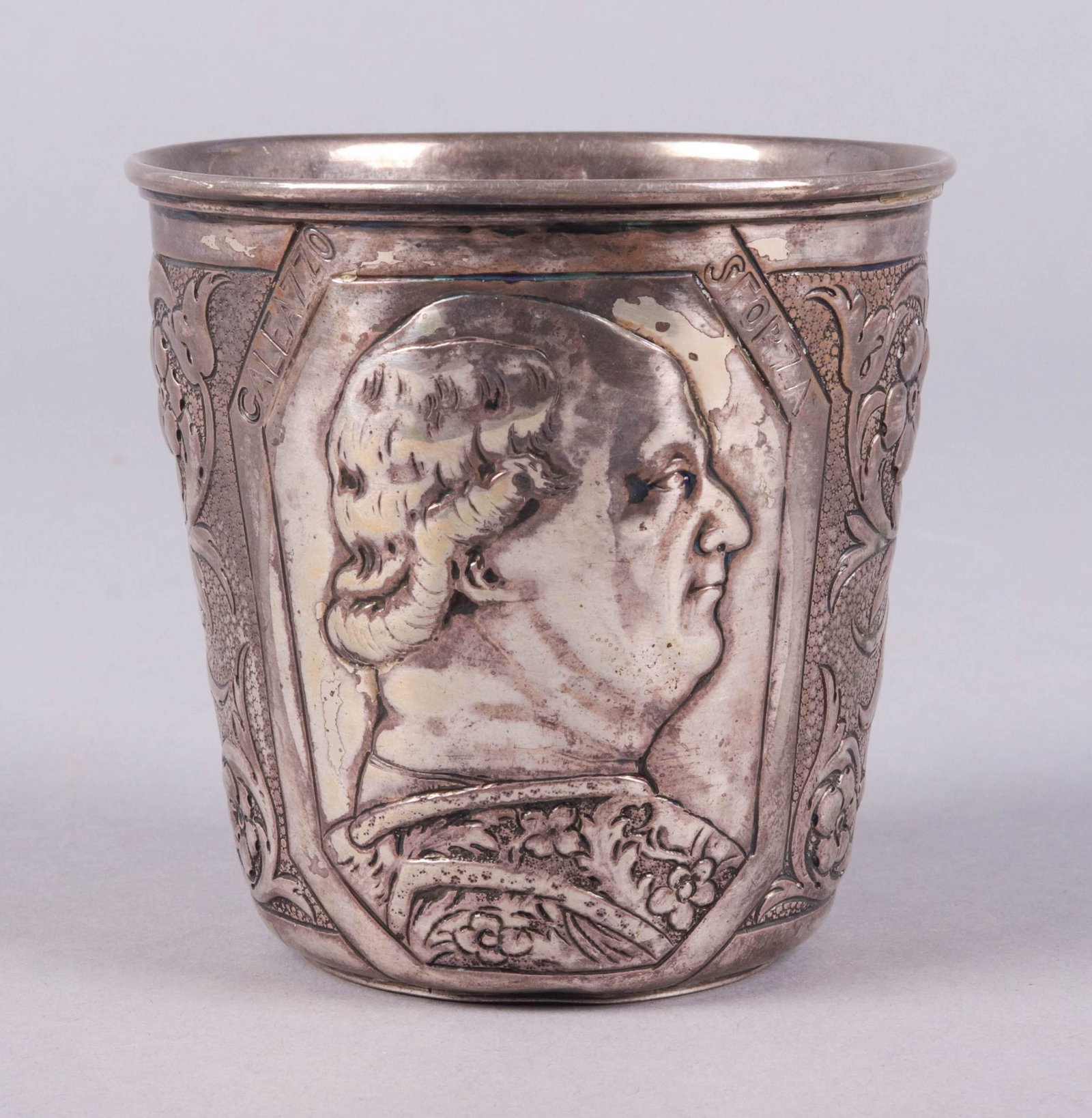Austro-Hungarian Silver Repousse Tumbler: Austro-Hungarian silver repousse tumbler, floral and foliage decorated with profile portrait of Caleazzo Sforza, 15th C Duke of Milan, 1872/1901 Austro-Hungarian import mark at underside, lion and rub