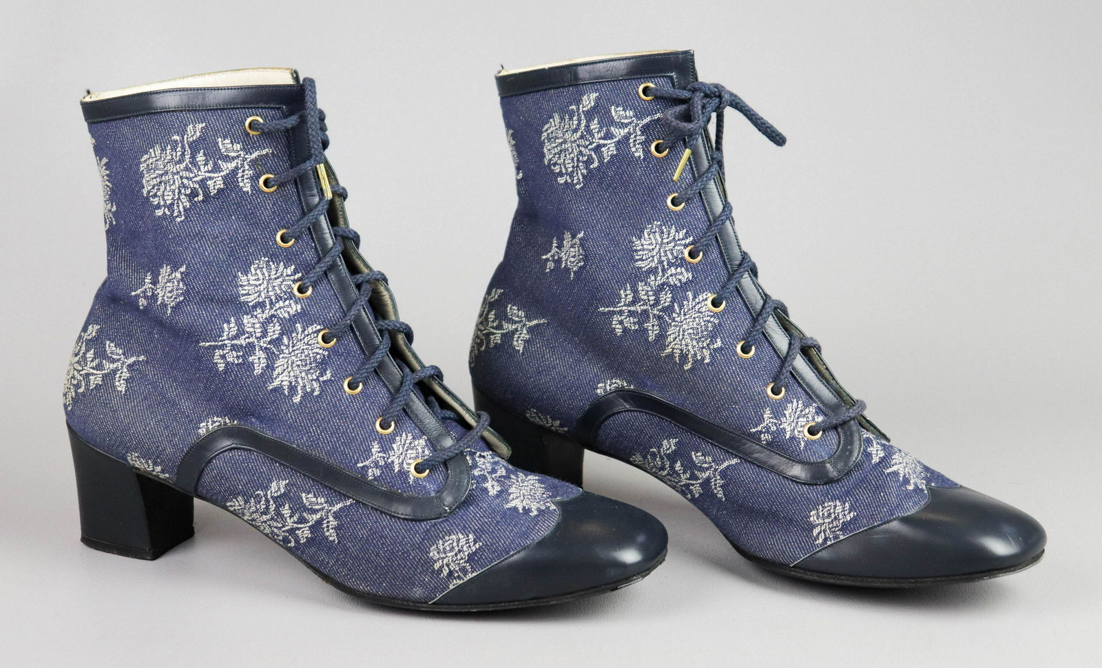 1970's Roger Vivier Floral Twill Boots: 1970's Roger Vivier floral twill boots, lace front, iin grey floral allover embroidery. Navy blue leather toe cap, trim and heel, lined in pale grey leather. 8-1/2