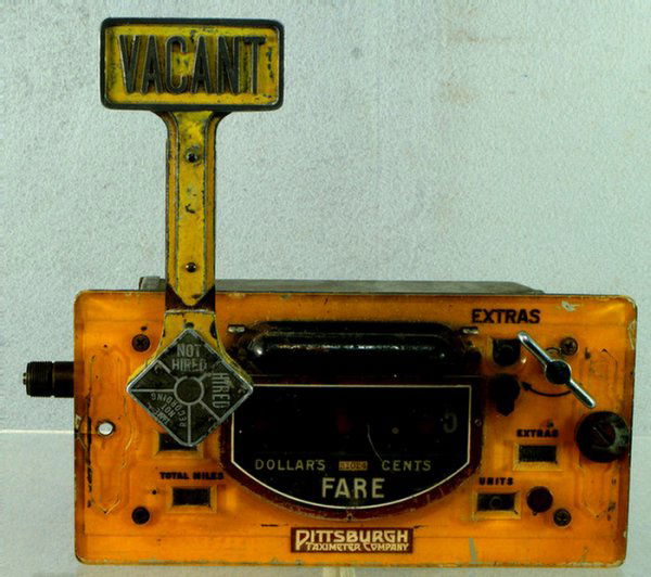 Yellow painted taxi meter by Pittsburgh Taximeter C: Yellow painted taxi meter by Pittsburgh Taximeter Company, 10 3/8" w, 5 1/4" h, seems to function