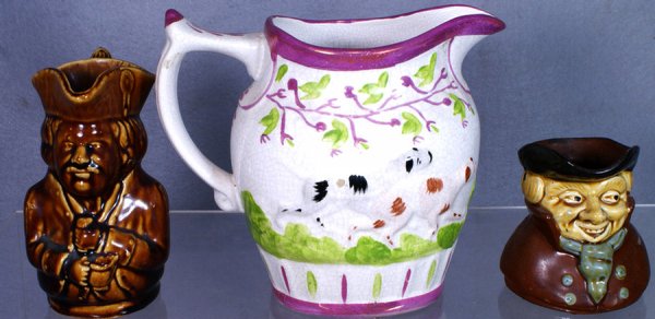 Pink luster pitcher with embossed dog, 7" h, with : Pink luster pitcher with embossed dog, 7" h, with a Rockingham Toby pitcher and another brown glazed Toby character jug, 6" & 4" tall, no damage
