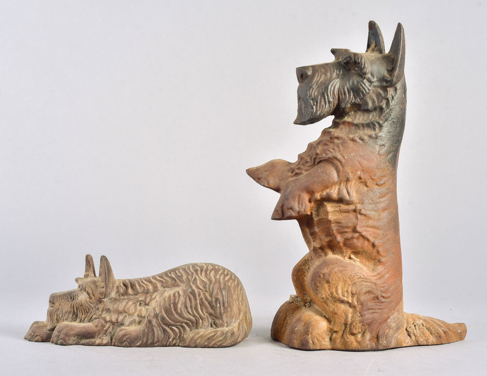 (2) Cast Iron Scottish Terrier Doorstops: (2) Cast iron Scottish Terrier door stops incl upright seated, 16-1/4" H and laying, 11-1/2" L
