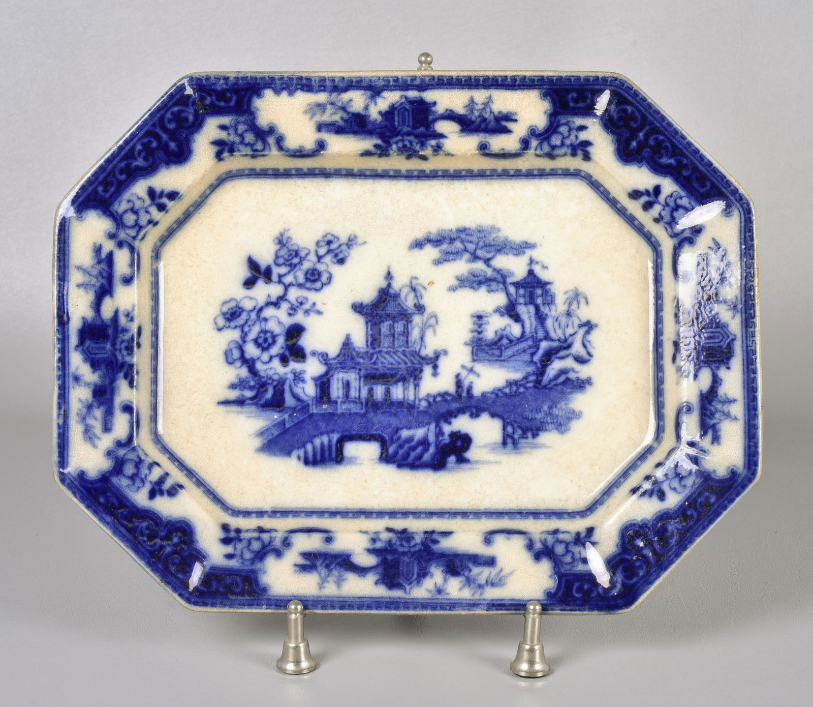 Flow Blue Porcelain Peking Platter: Flow blue porcelain octagonal platter, Peking pattern, overall crazing & staining, hairlines, 15-1/4" x 11-3/4", with chrome stand